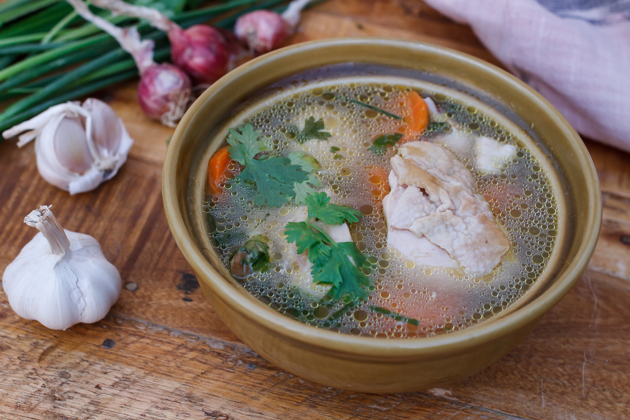 chicken soup on wooden background,selection focus.