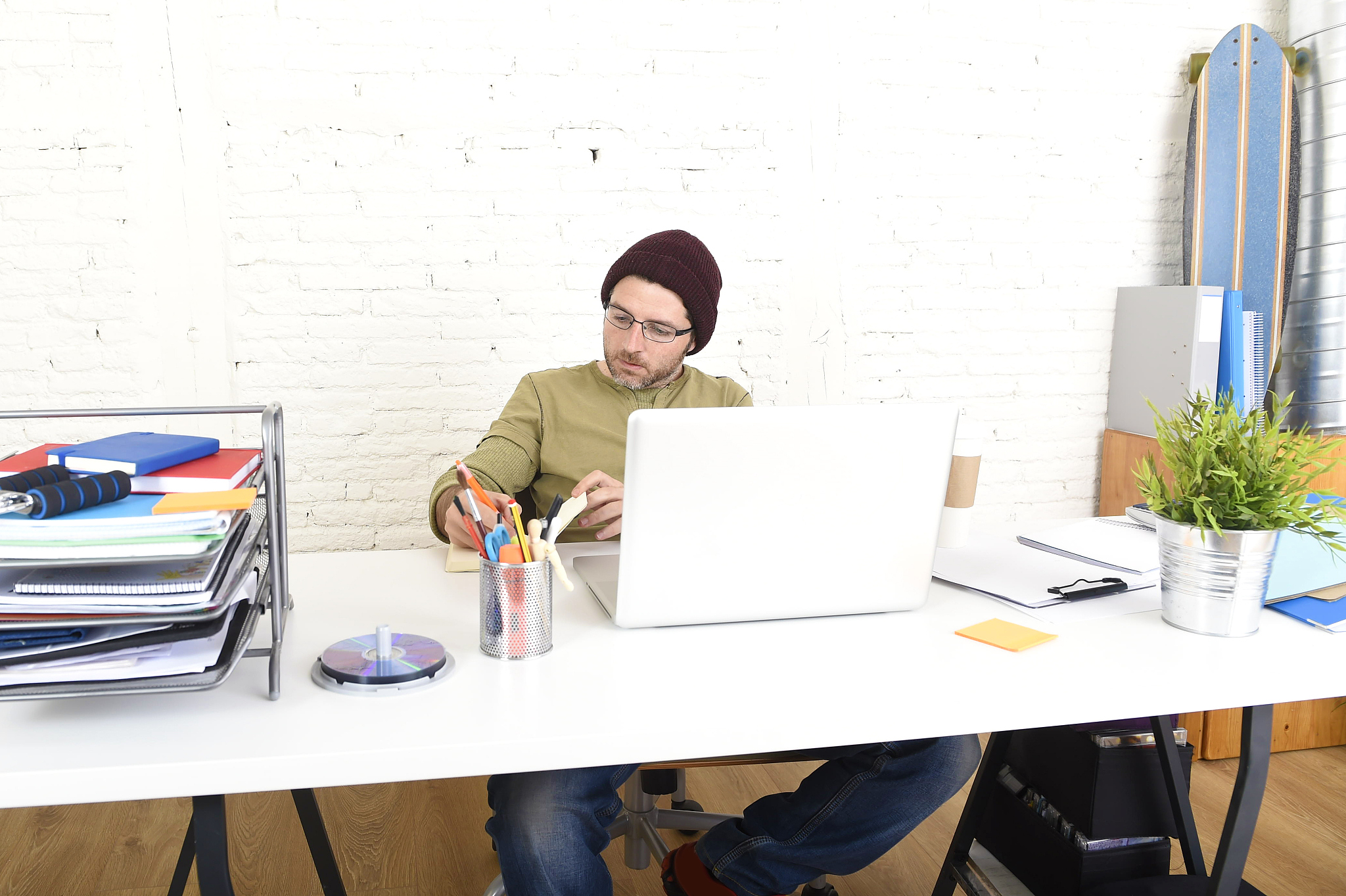 young hipster businessman working from home office as freelancer