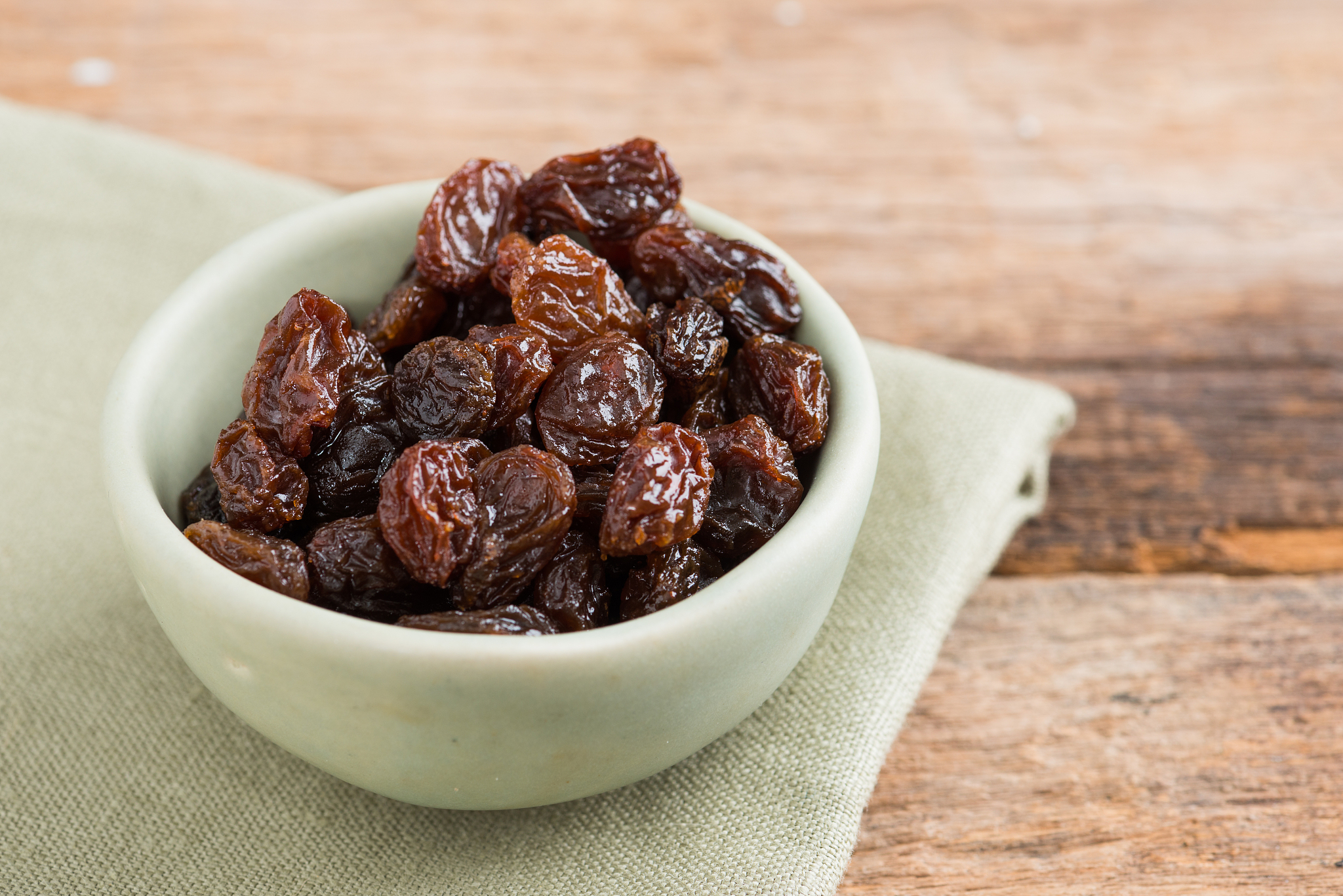 raisins on a wood background.