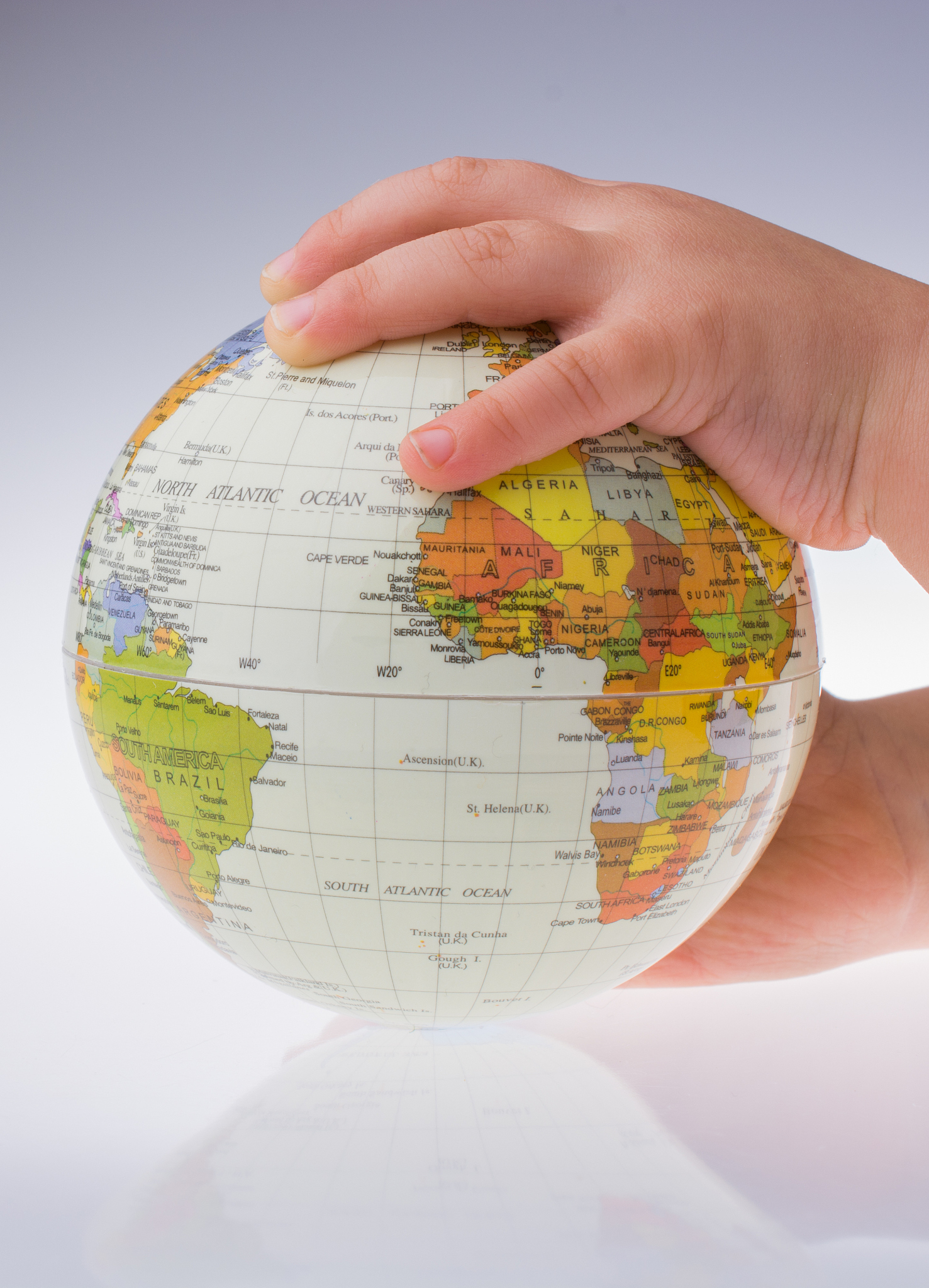 child holding a globe in his hand