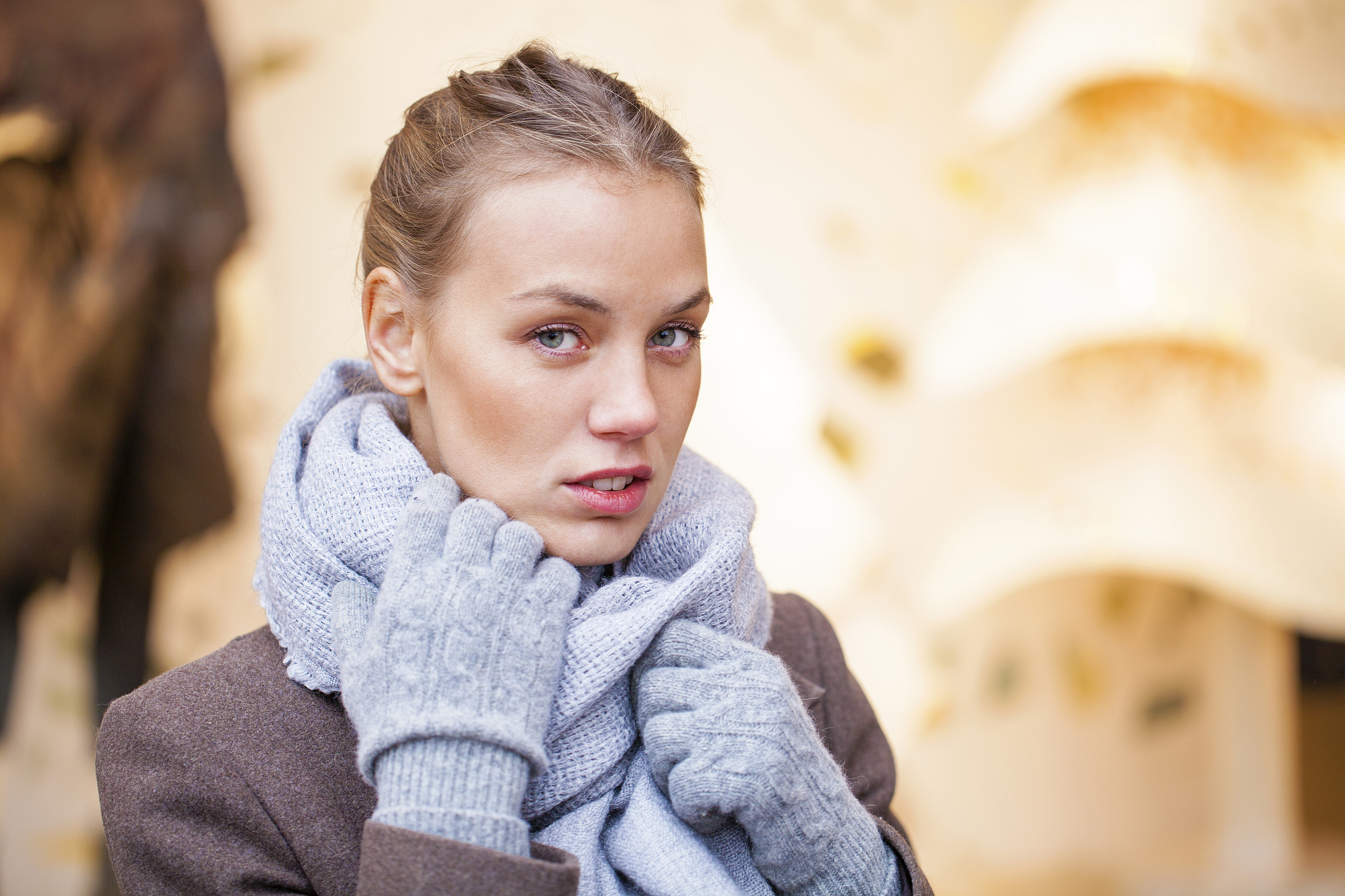 portrait of a young beautiful woman in gray coat