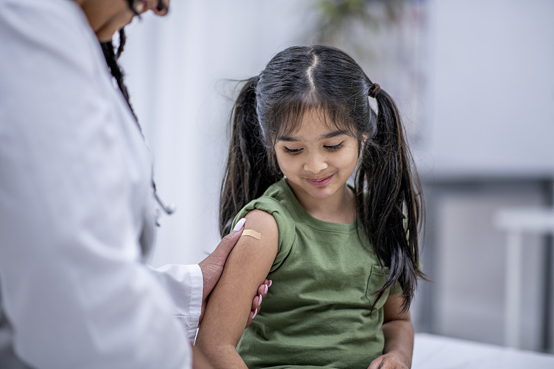 band aid on arm after a flu shot stock photo