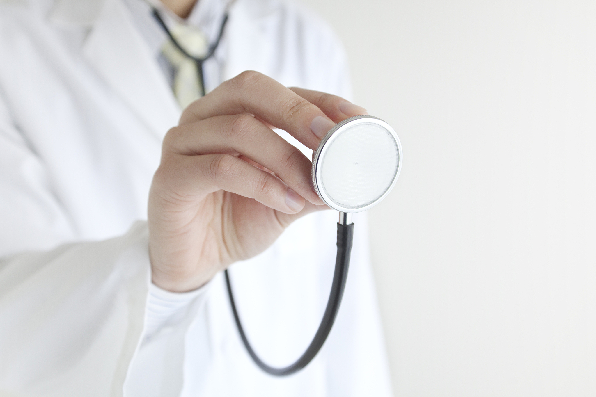 the hands of the doctor with a stethoscope