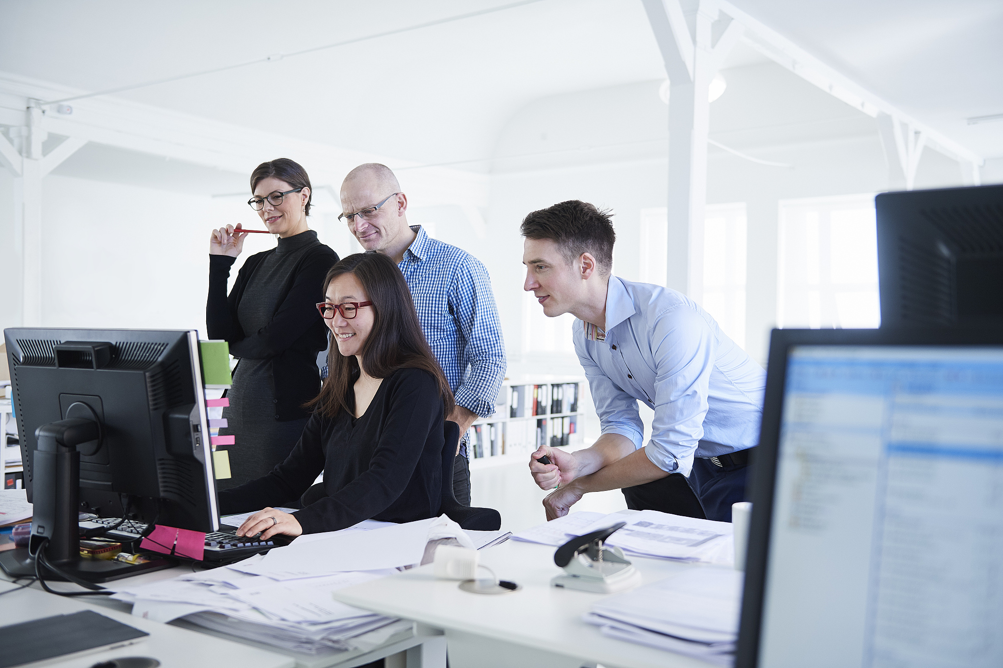colleagues working in office, using computer