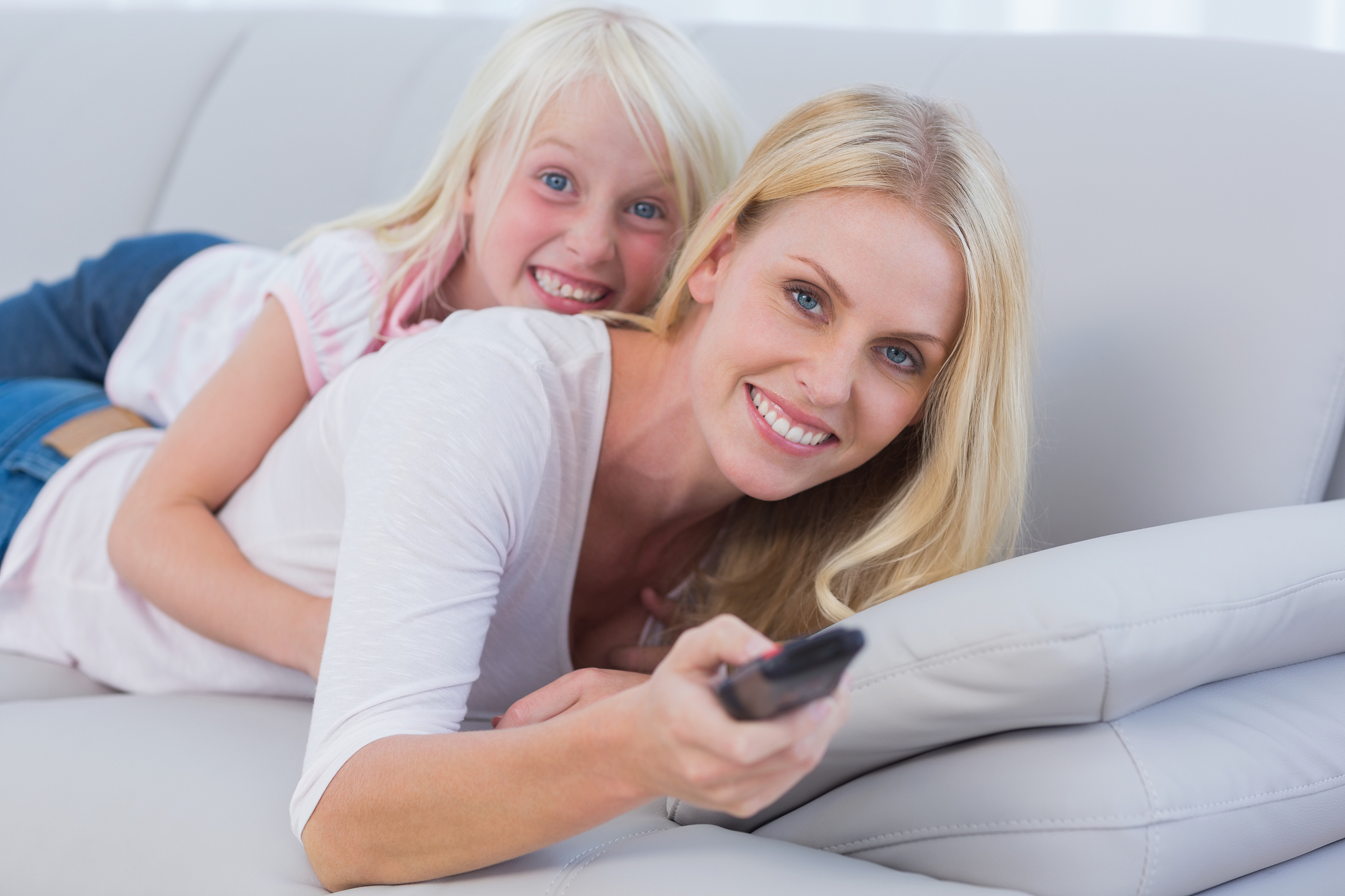 mother and her daughter watching tv