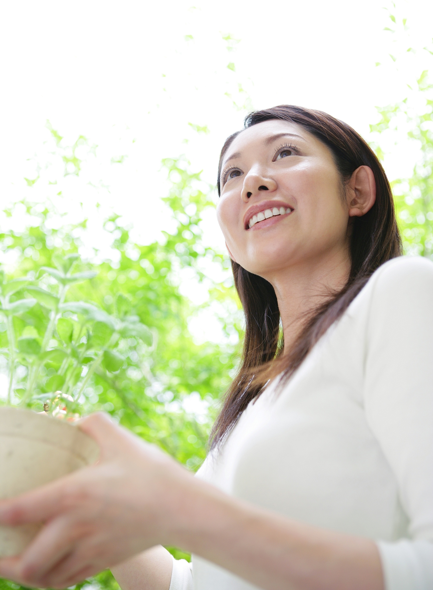 woman holding potplants.smiling