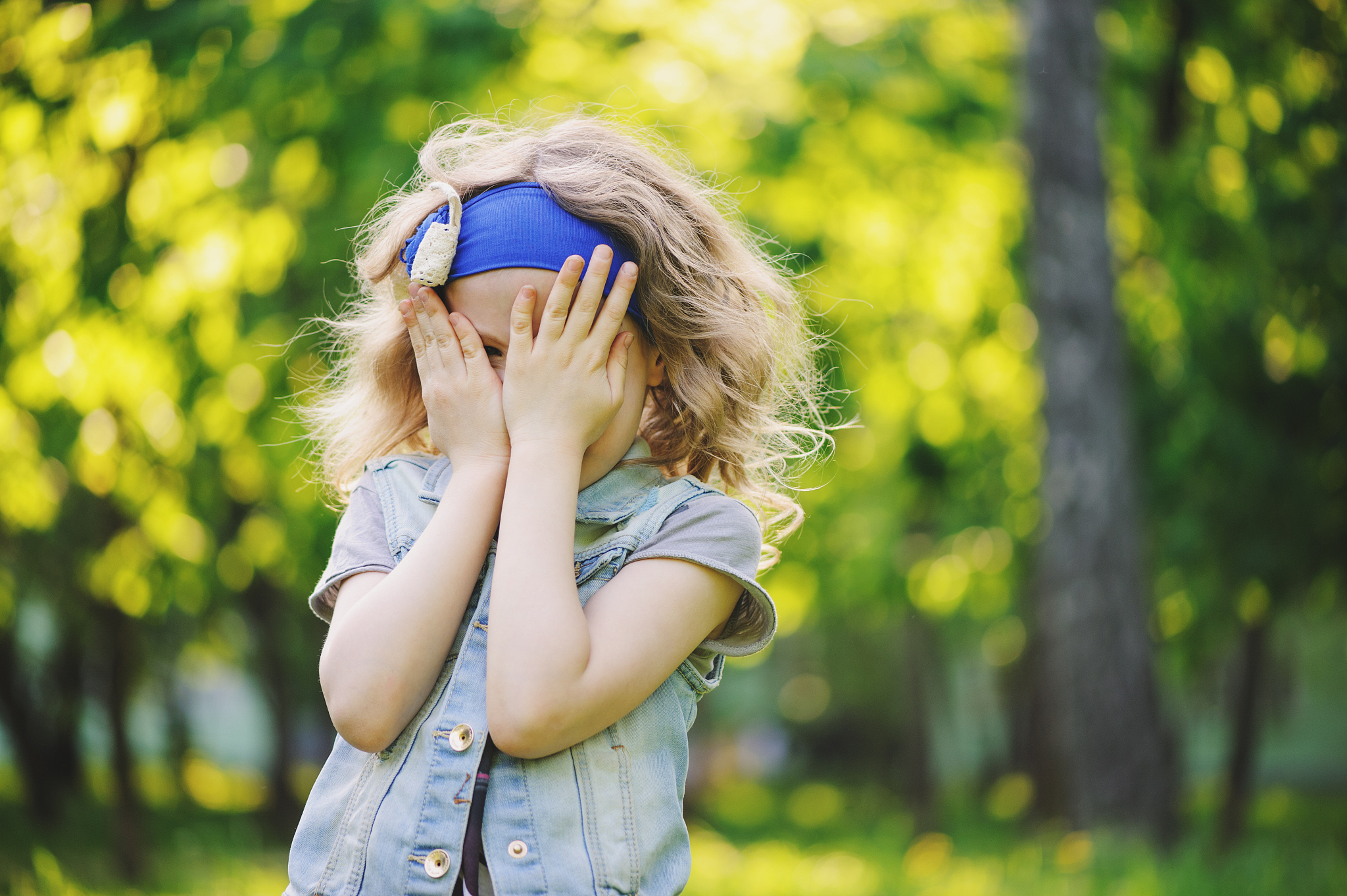 happy child girl playing on colorful spring field