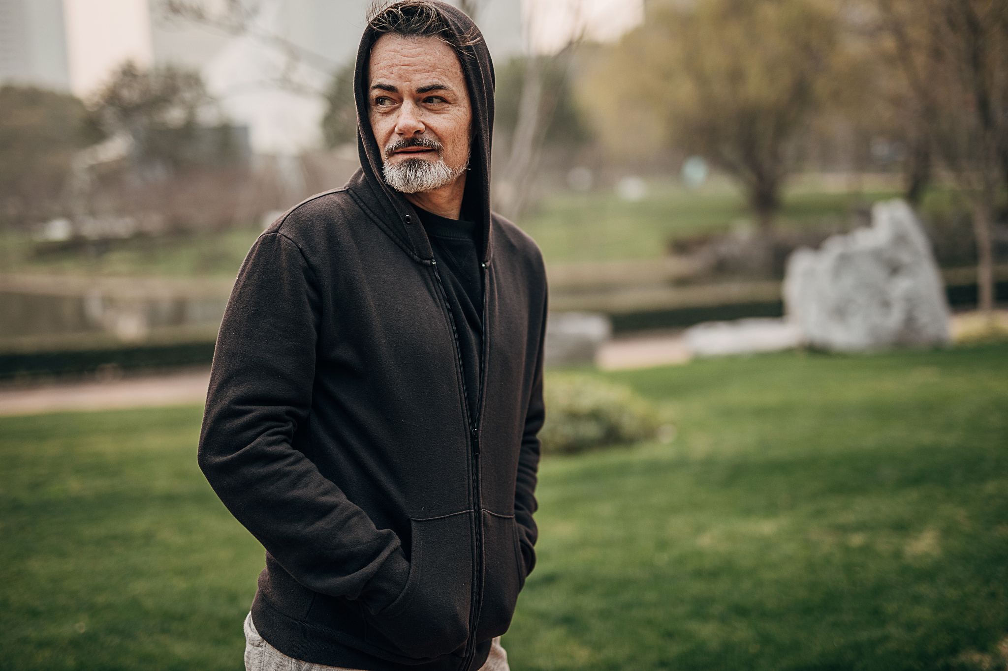 mature man in sports clothing walking in public park