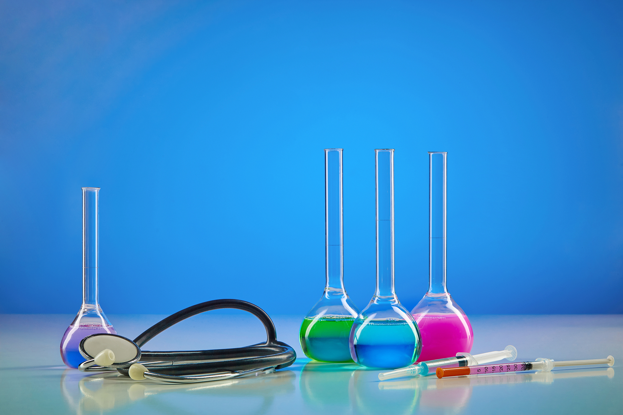 four medical flasks with colorful chemical reagents. testing kit
