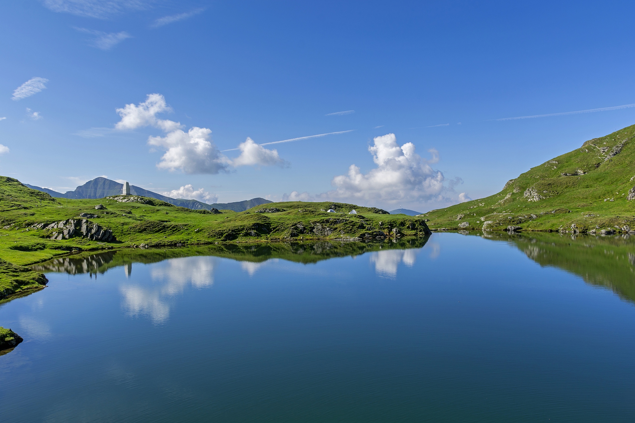 beautiful view of  mountain lake with sky mirrored in water.