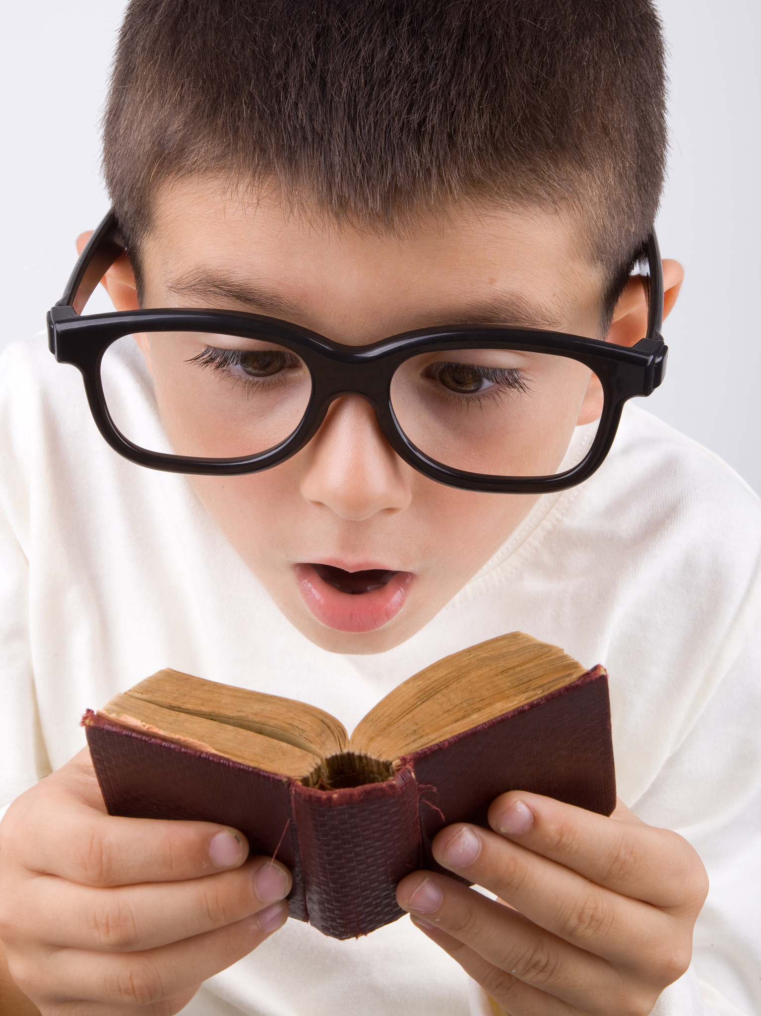 nerd little boy with large glasses and mini book