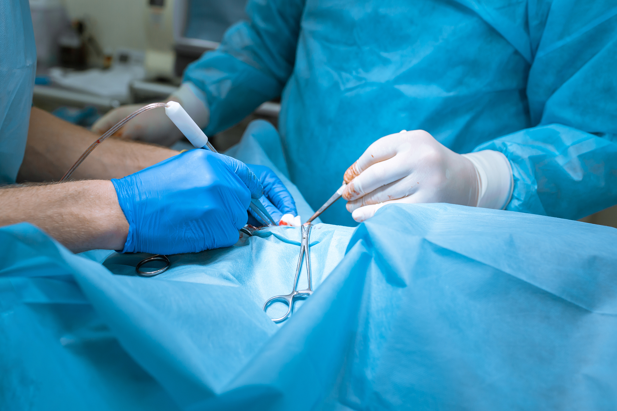 the surgeon applies a surgical clamp to stop the bleeding. group