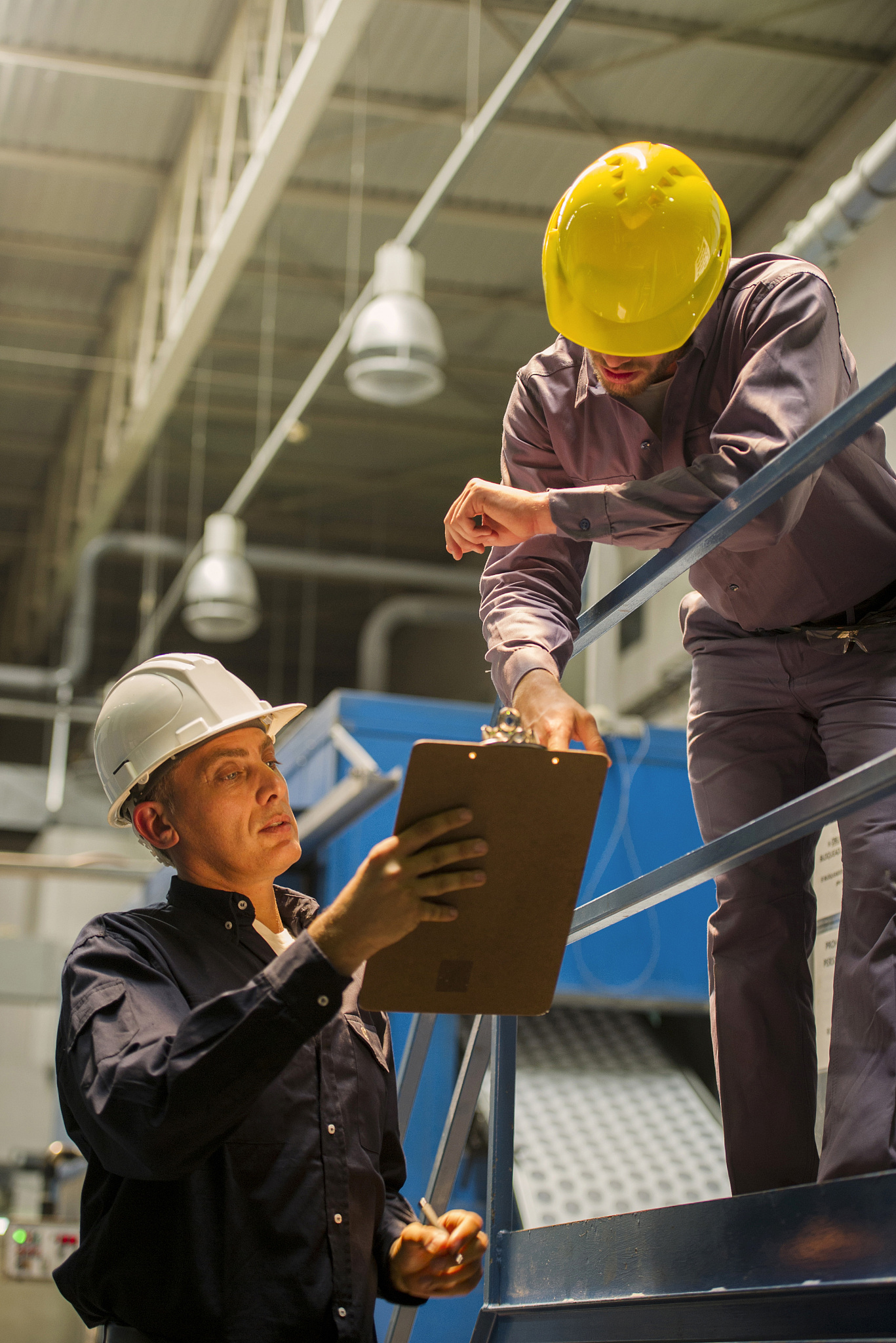 factory workers with clipboard in factory