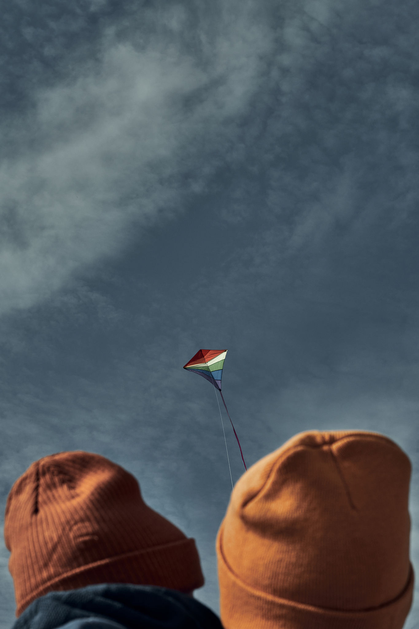 a woman with a two-year-old child is flying a kite. games with c