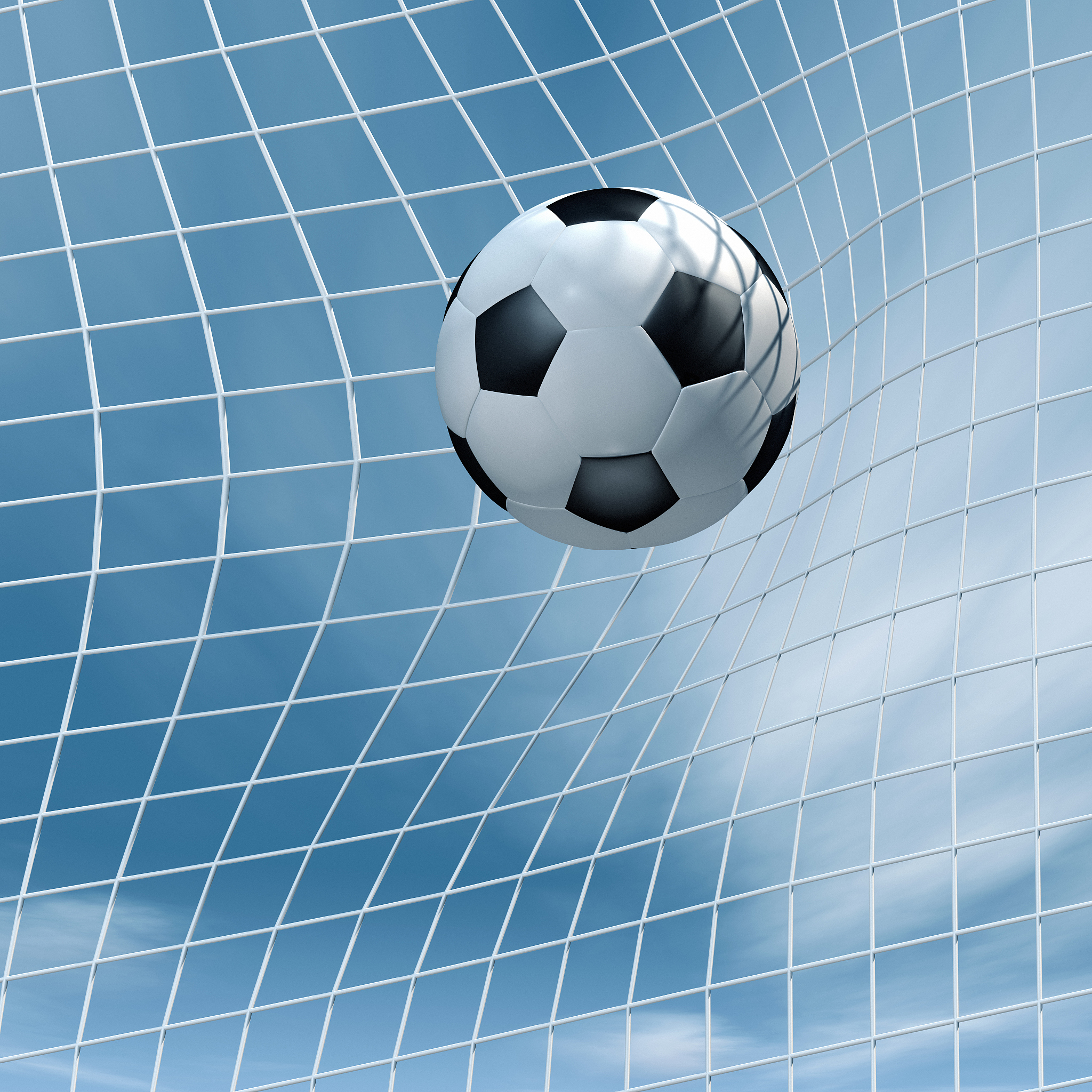 soccer ball flying into a goal