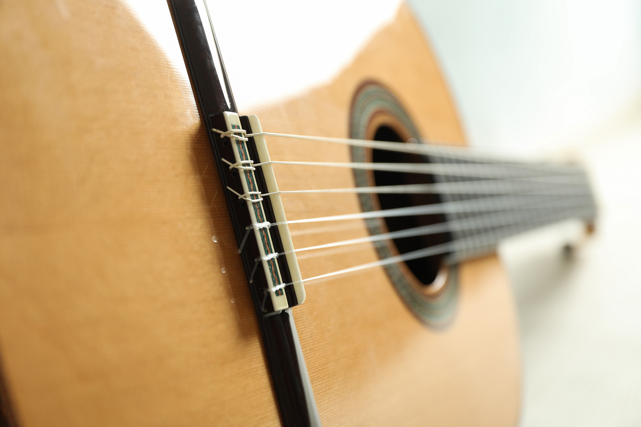 beautiful six - string classic guitar on white background, close