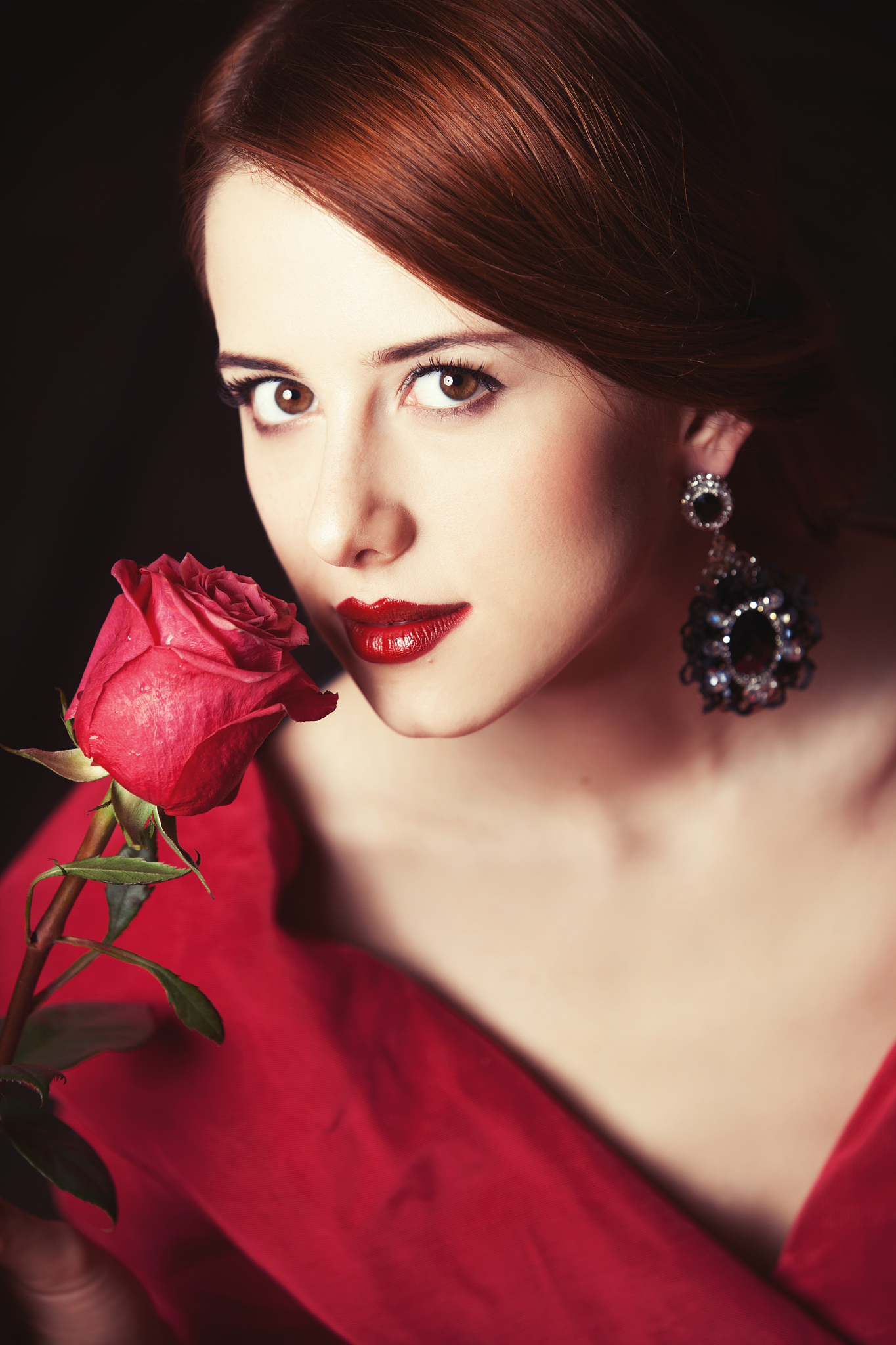 beautiful redhead women with rose.