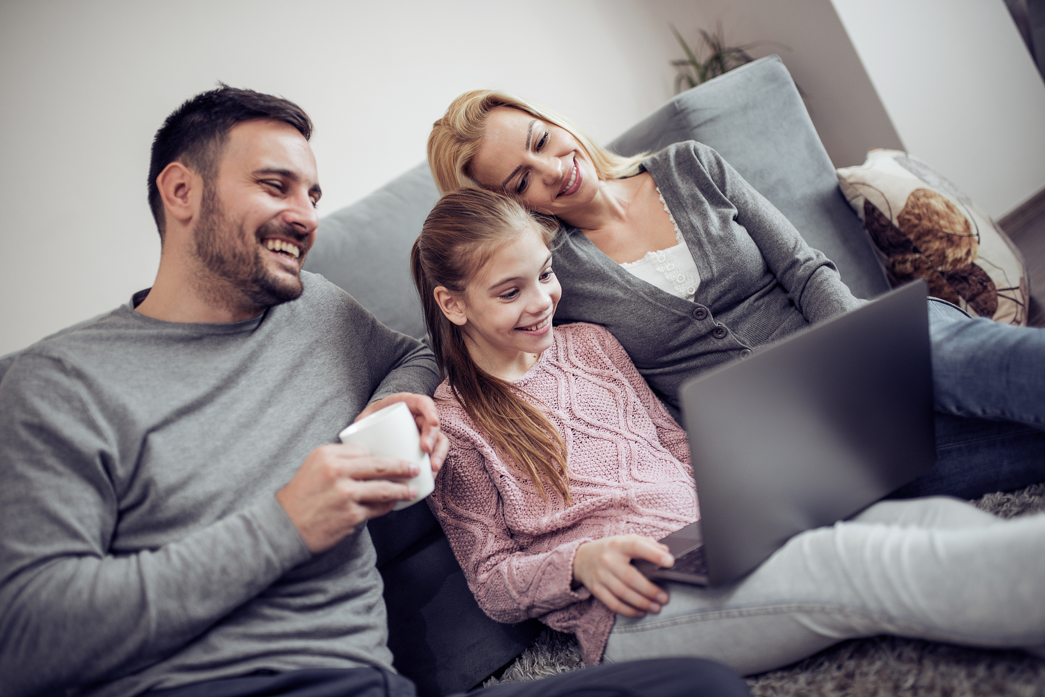 lovely family watching a movie on laptop at home
