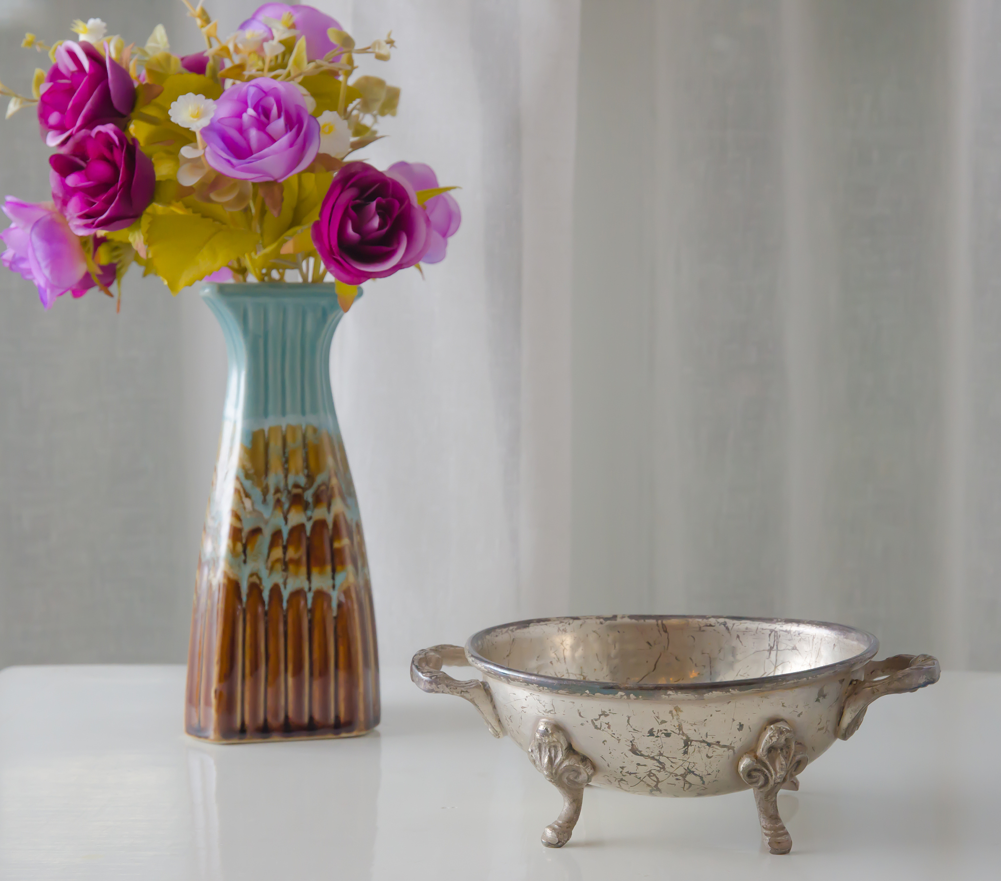 moroccan metal bowl with a vase of flowers.