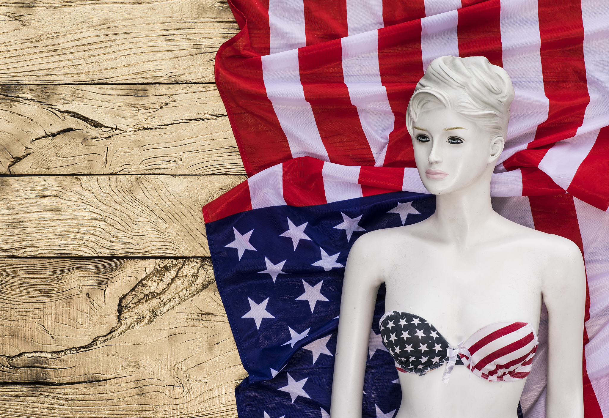 american flag and mannequin on a gold background
