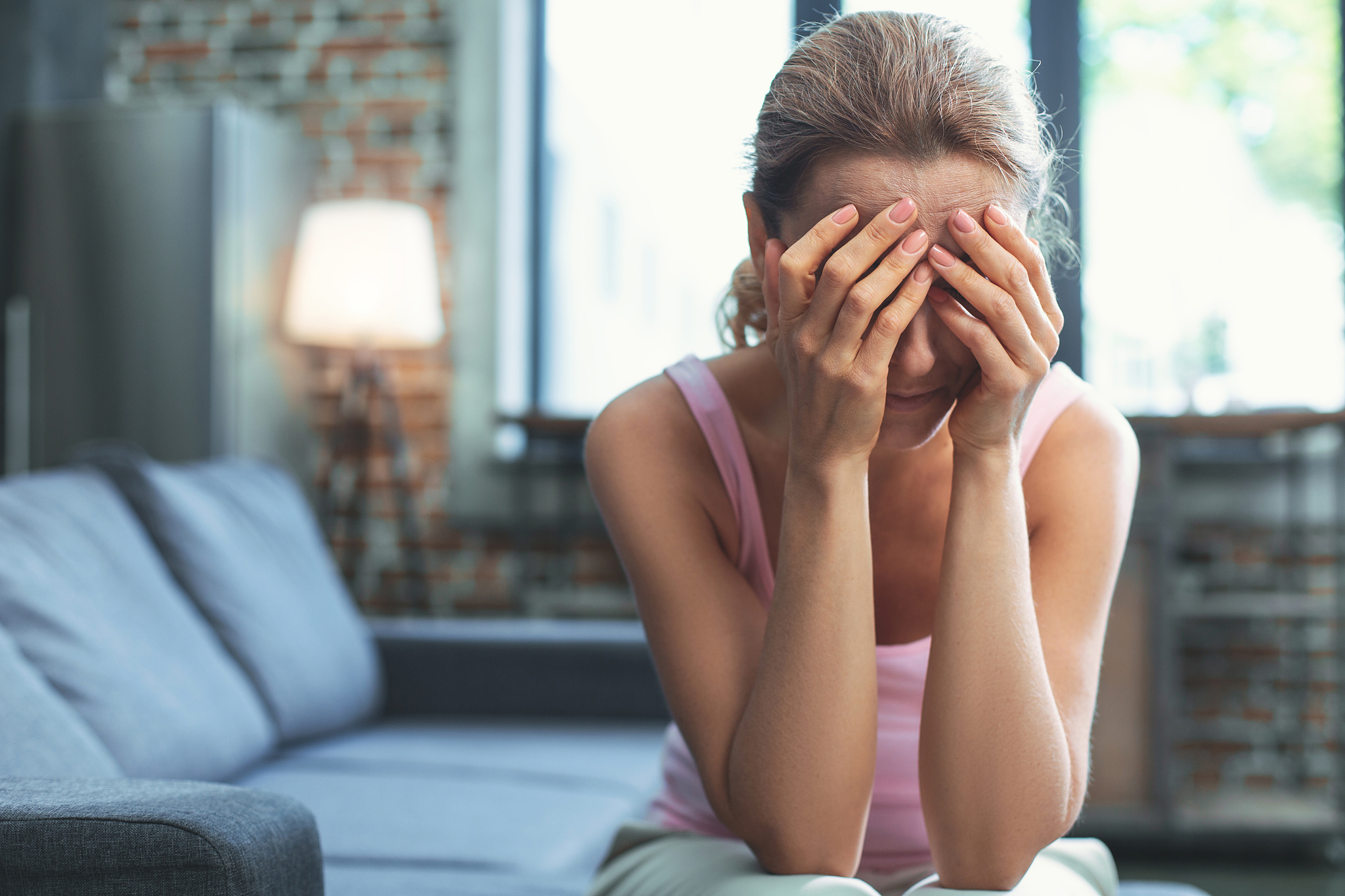 dissatisfied mature woman hiding from reality