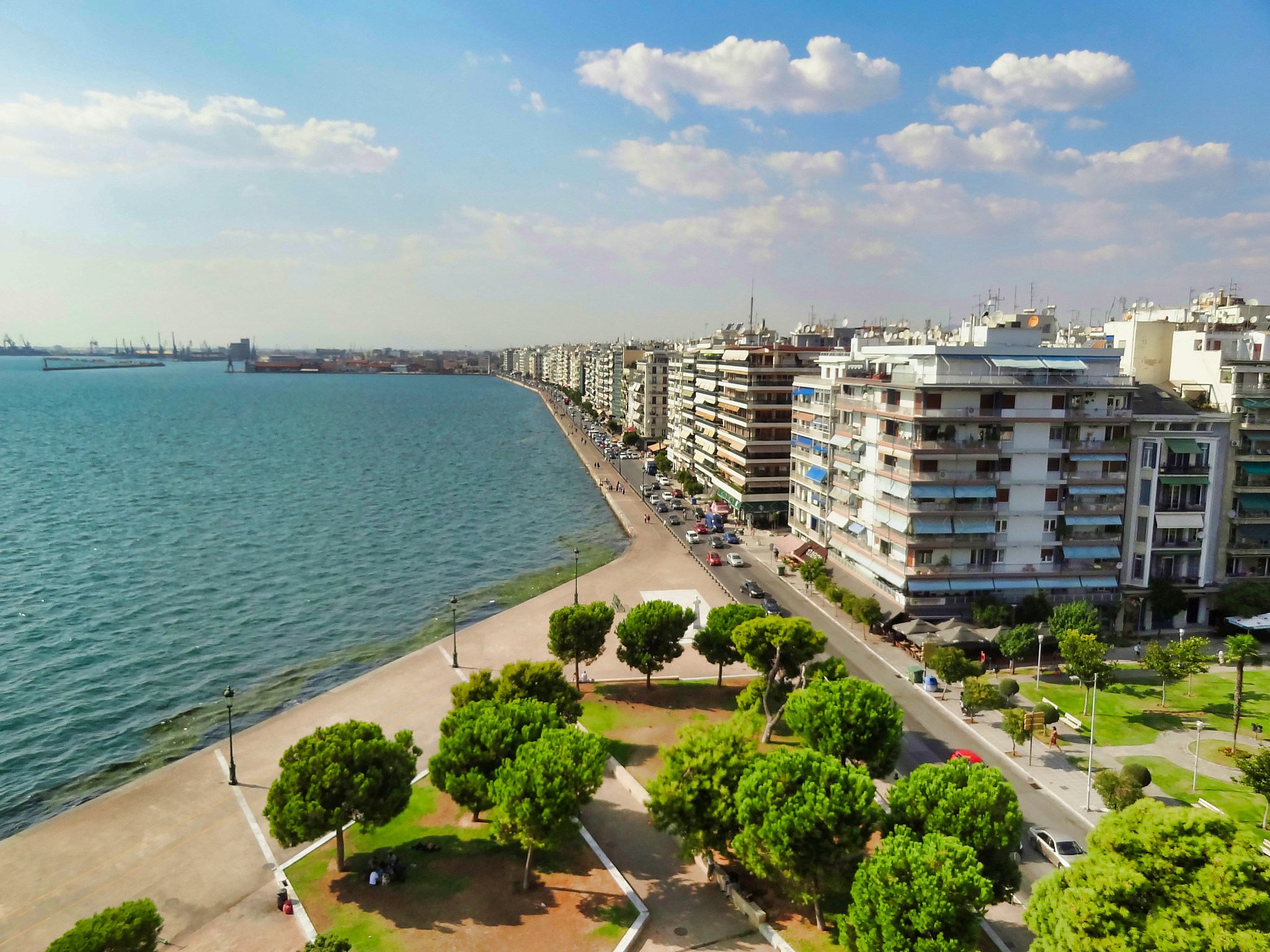 high angle view of buildings by sea against sky