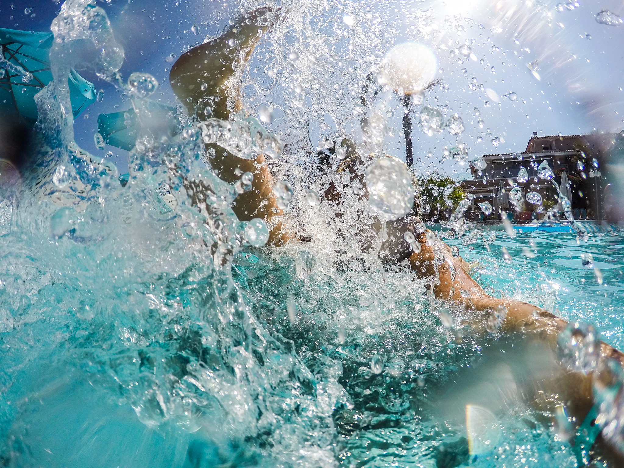 family splashing in swimming pool