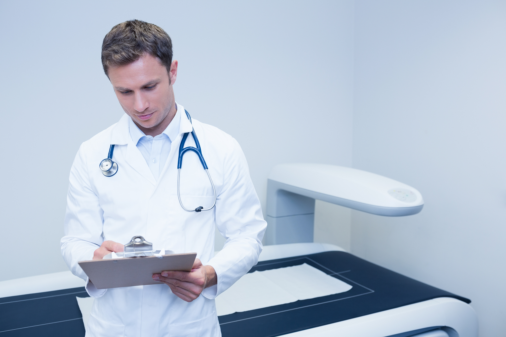 doctor noting something on his clipboard