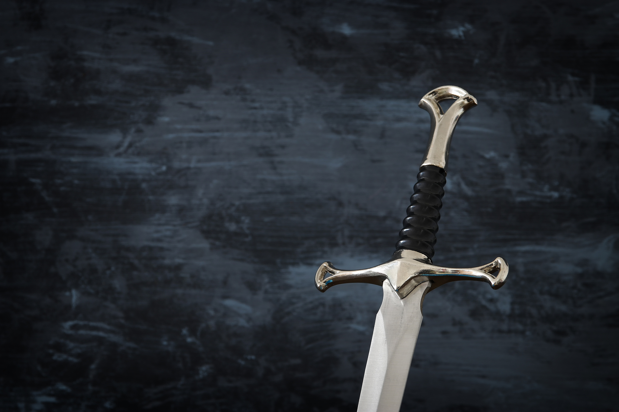 low key image of silver sword. fantasy medieval period.