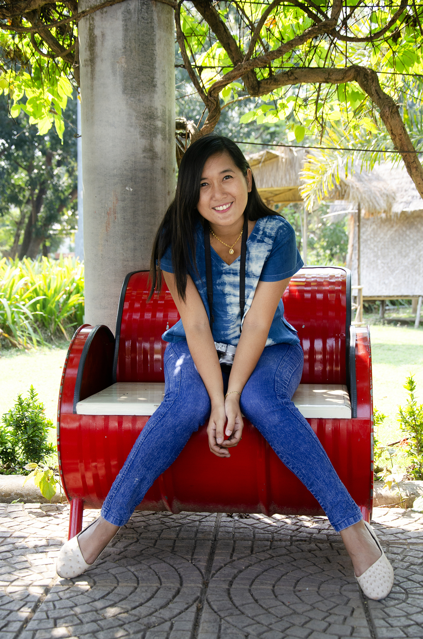 asia thai woman travel visit and sitting on red metal bench posi