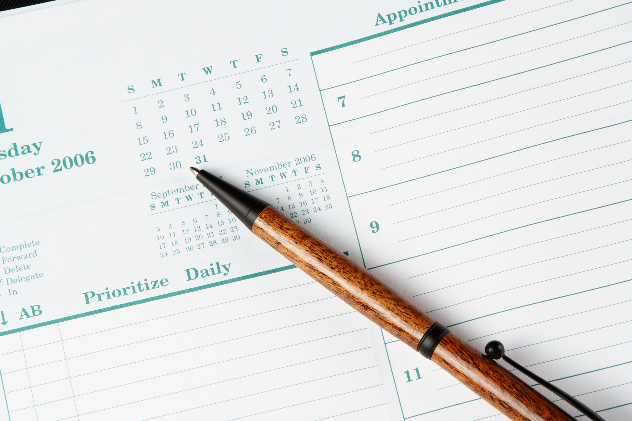 day planner page and a wooden pen