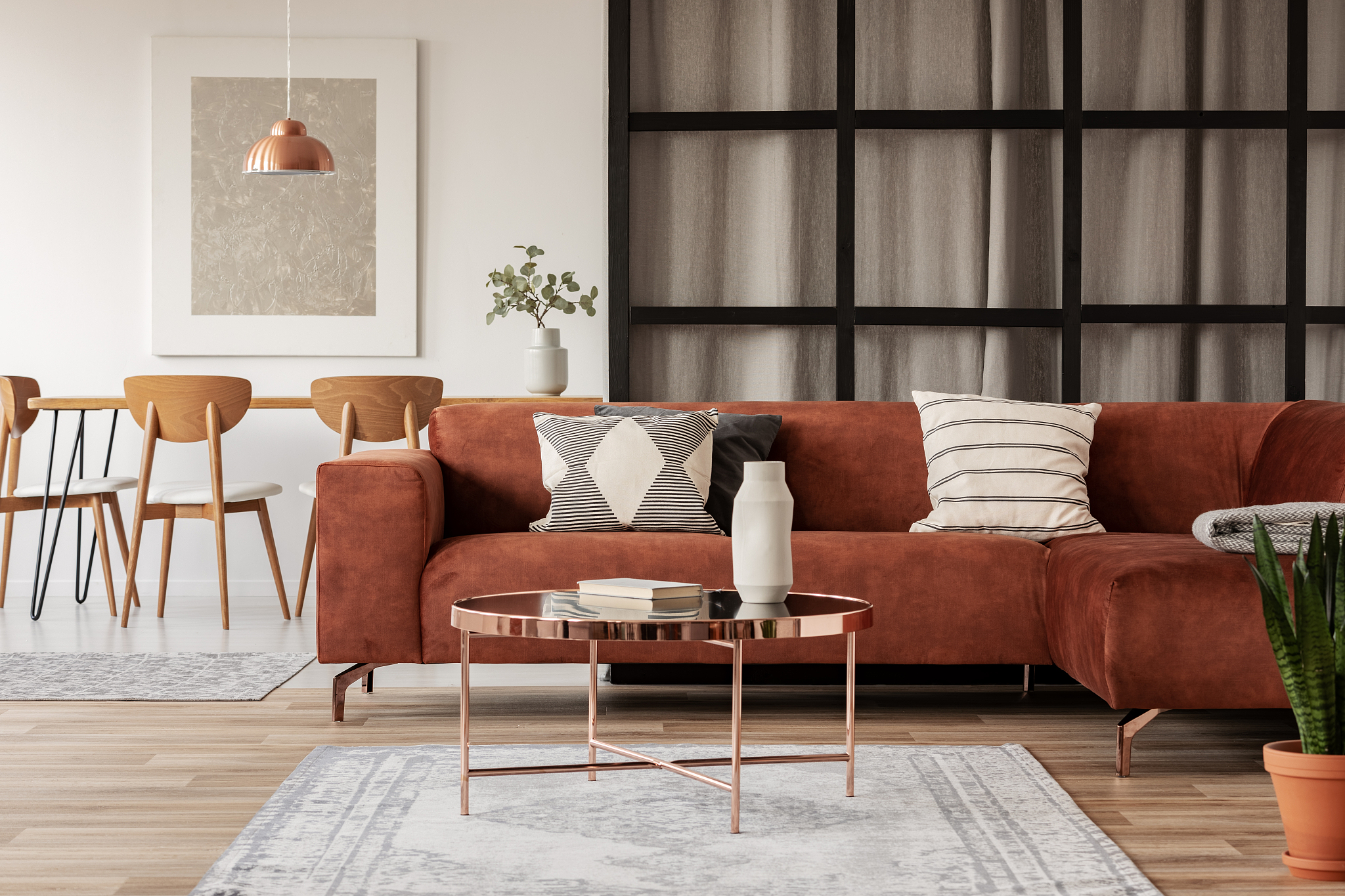 stylish brown corner sofa with patterned pillows in elegant livi