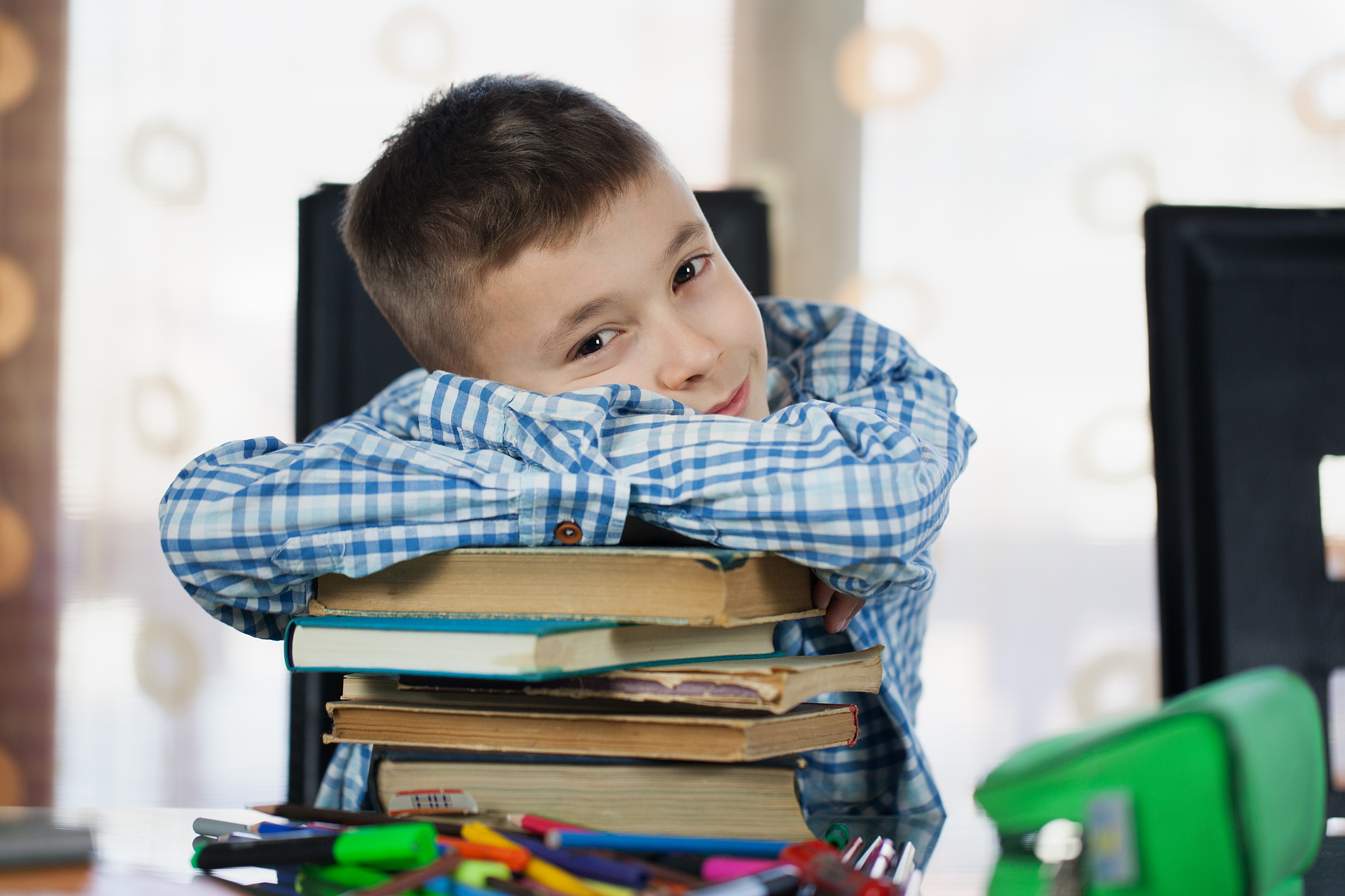 schoolboybeautiful schoolboy doing homework at home
