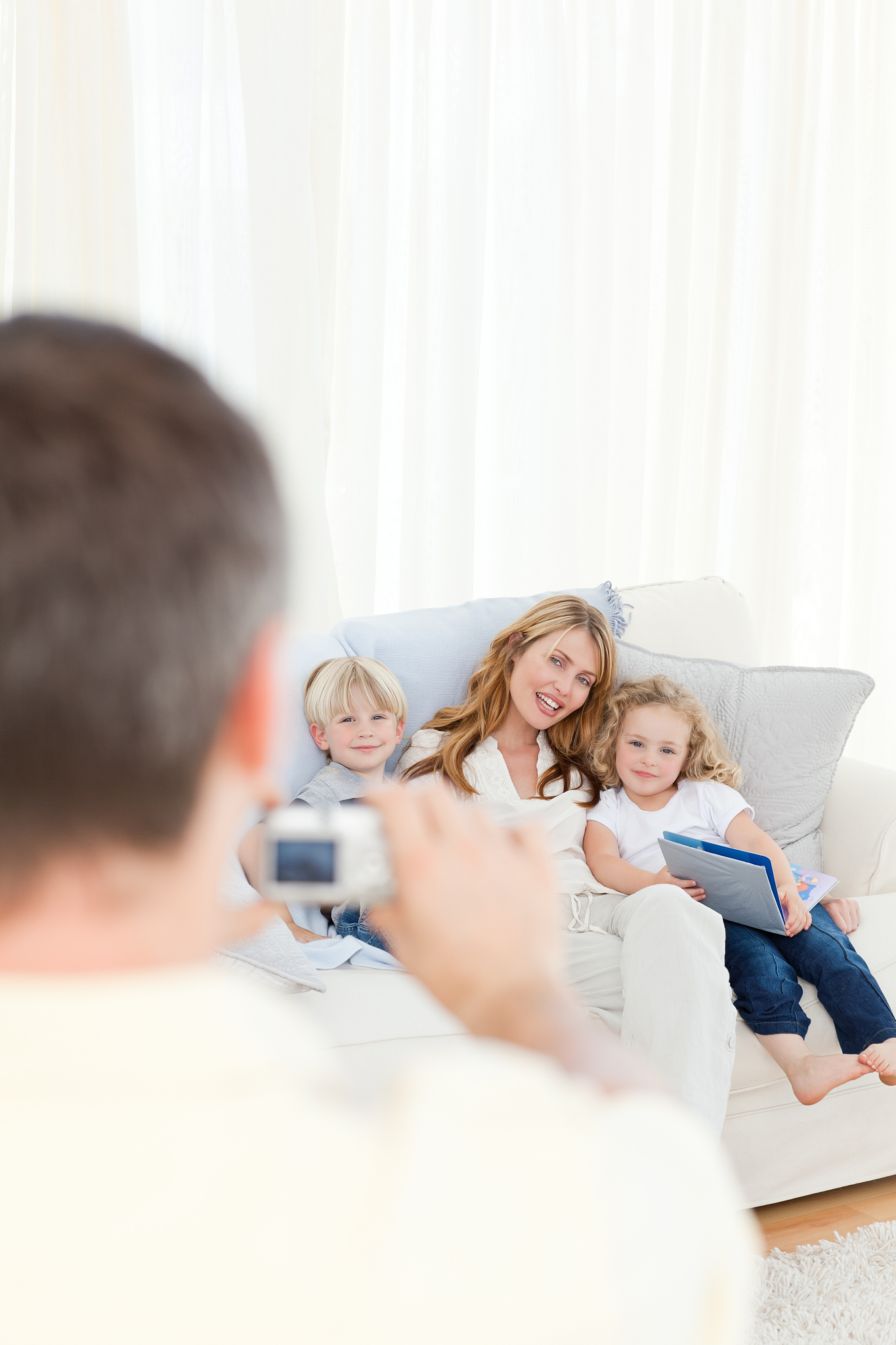 man taking a photo of his family