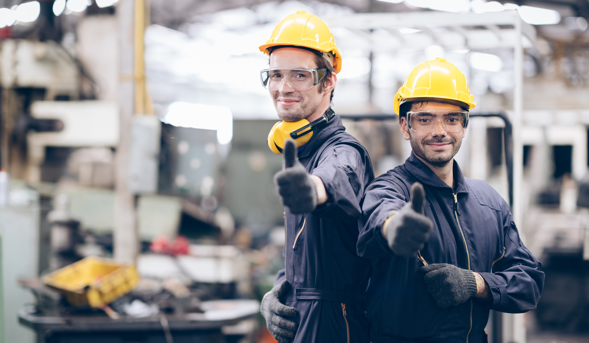 technician and partnership thump up and lokking camera at machin