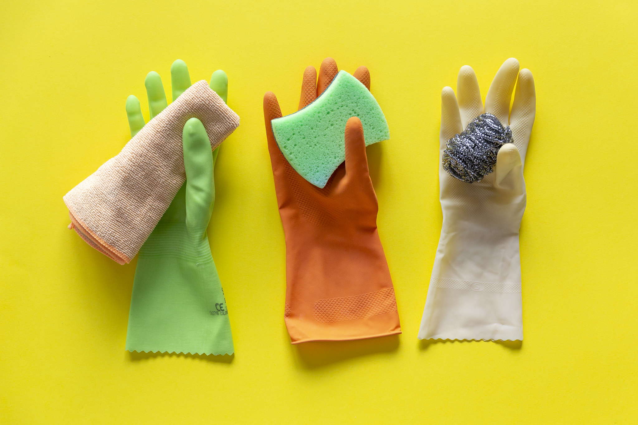 colorful washing up cleaning gloves, scourer, rag and sponge on 