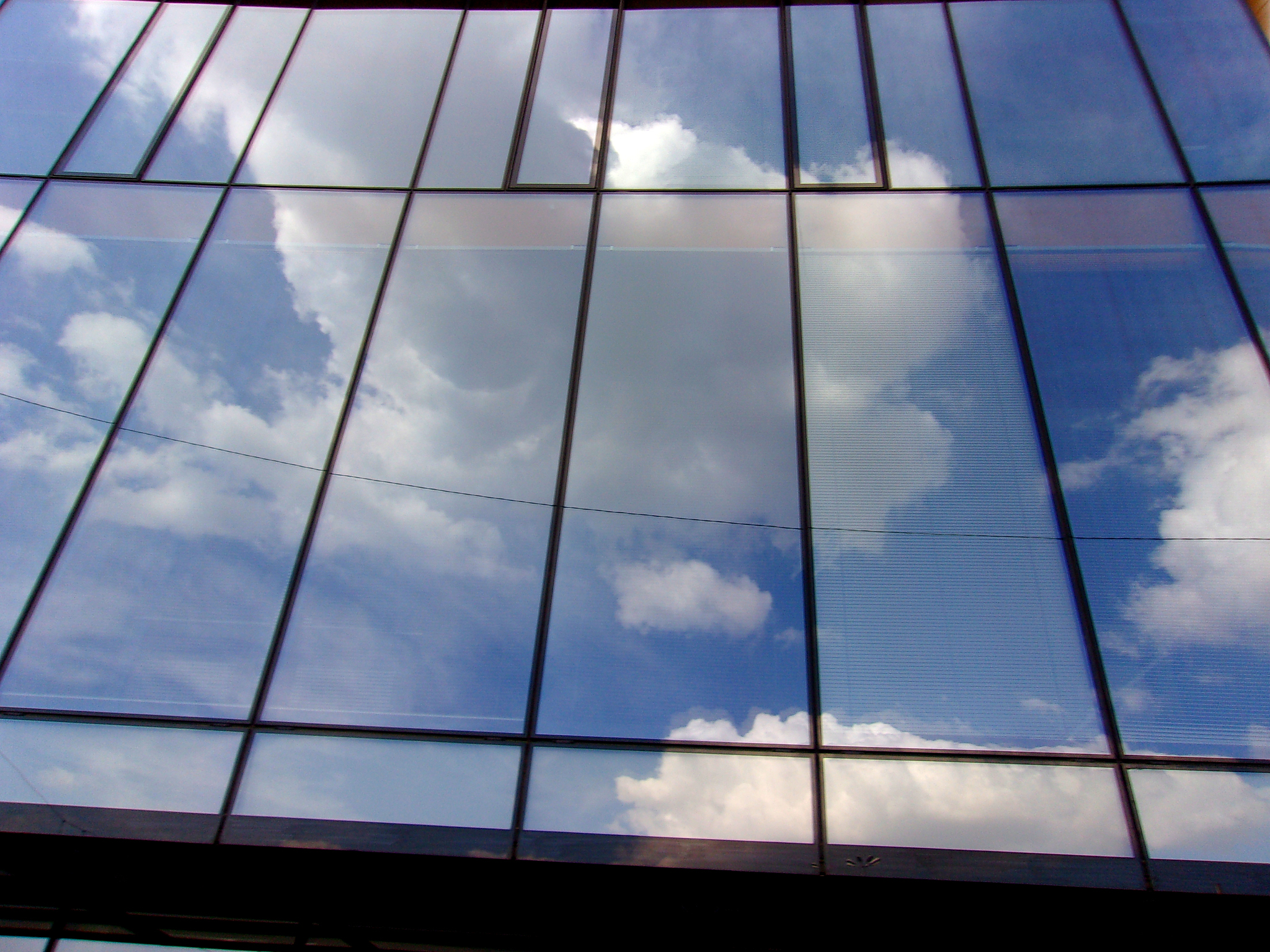 mirror wall building,reflecting sky and clouds