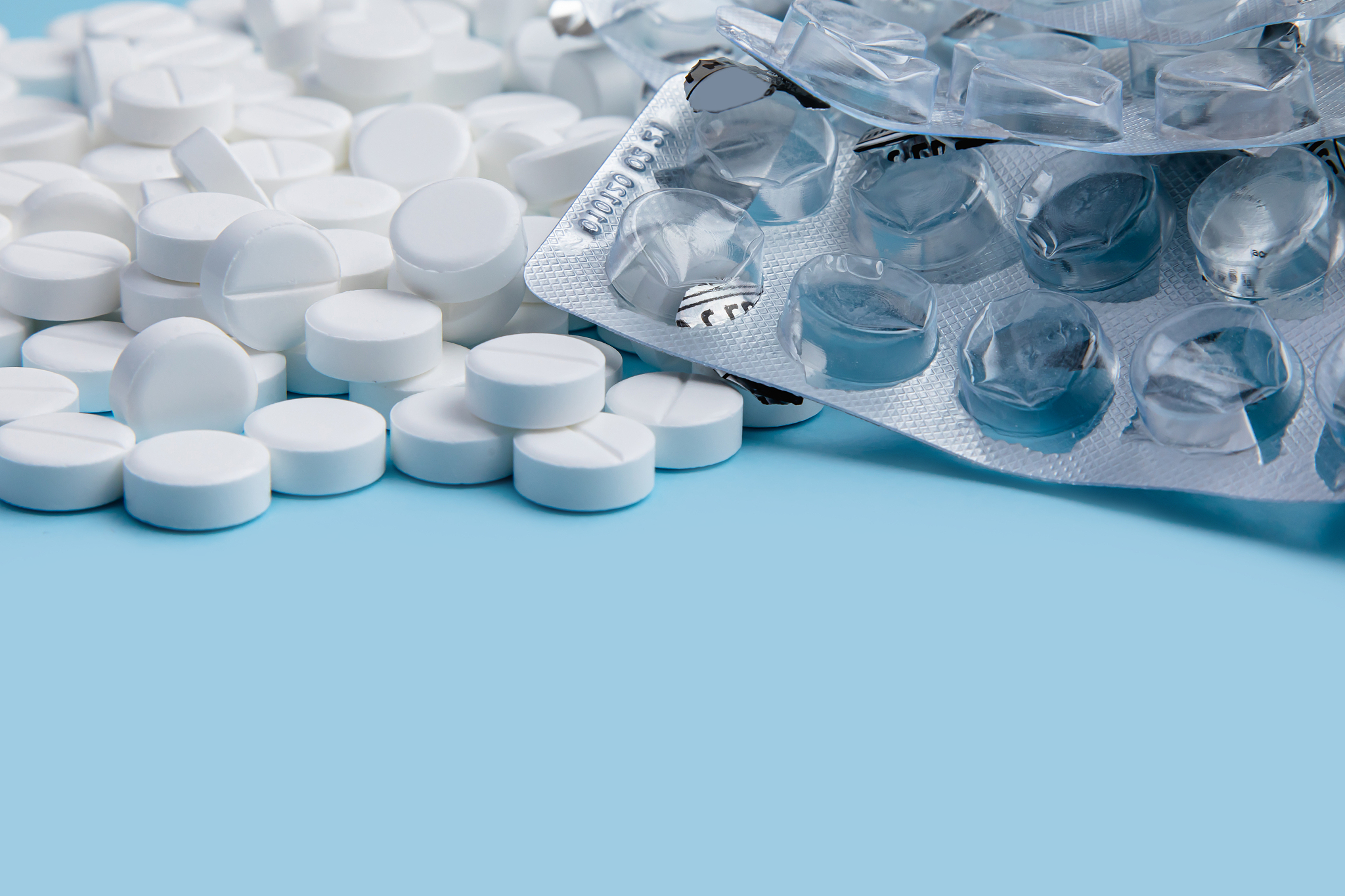 white pills on blue background