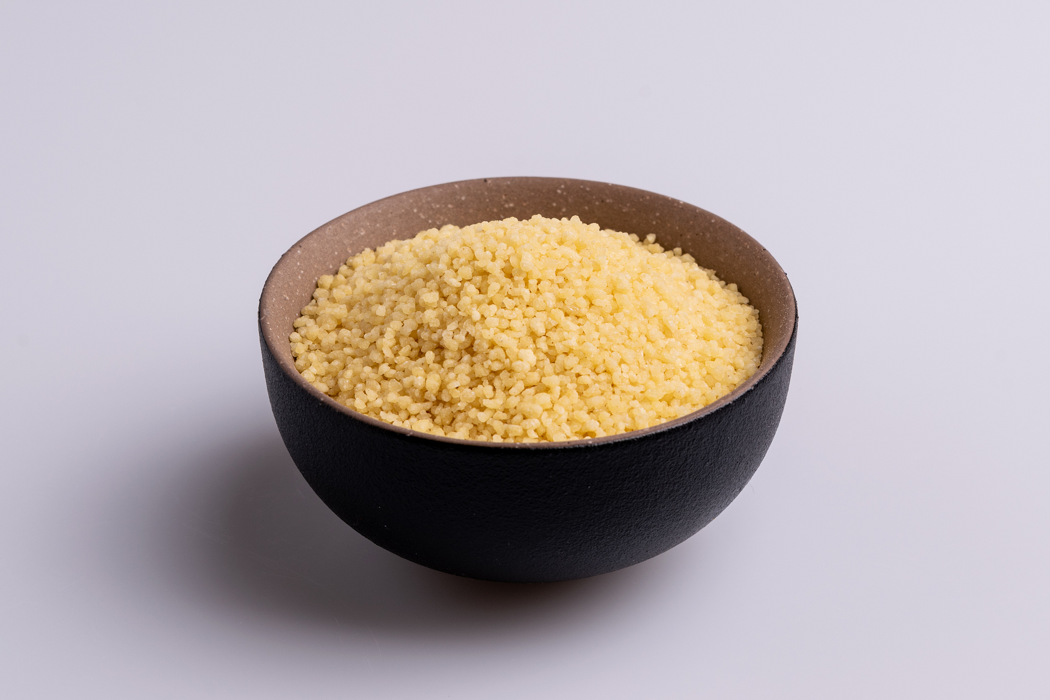dry couscous isolated on white background, soft light, copy spac