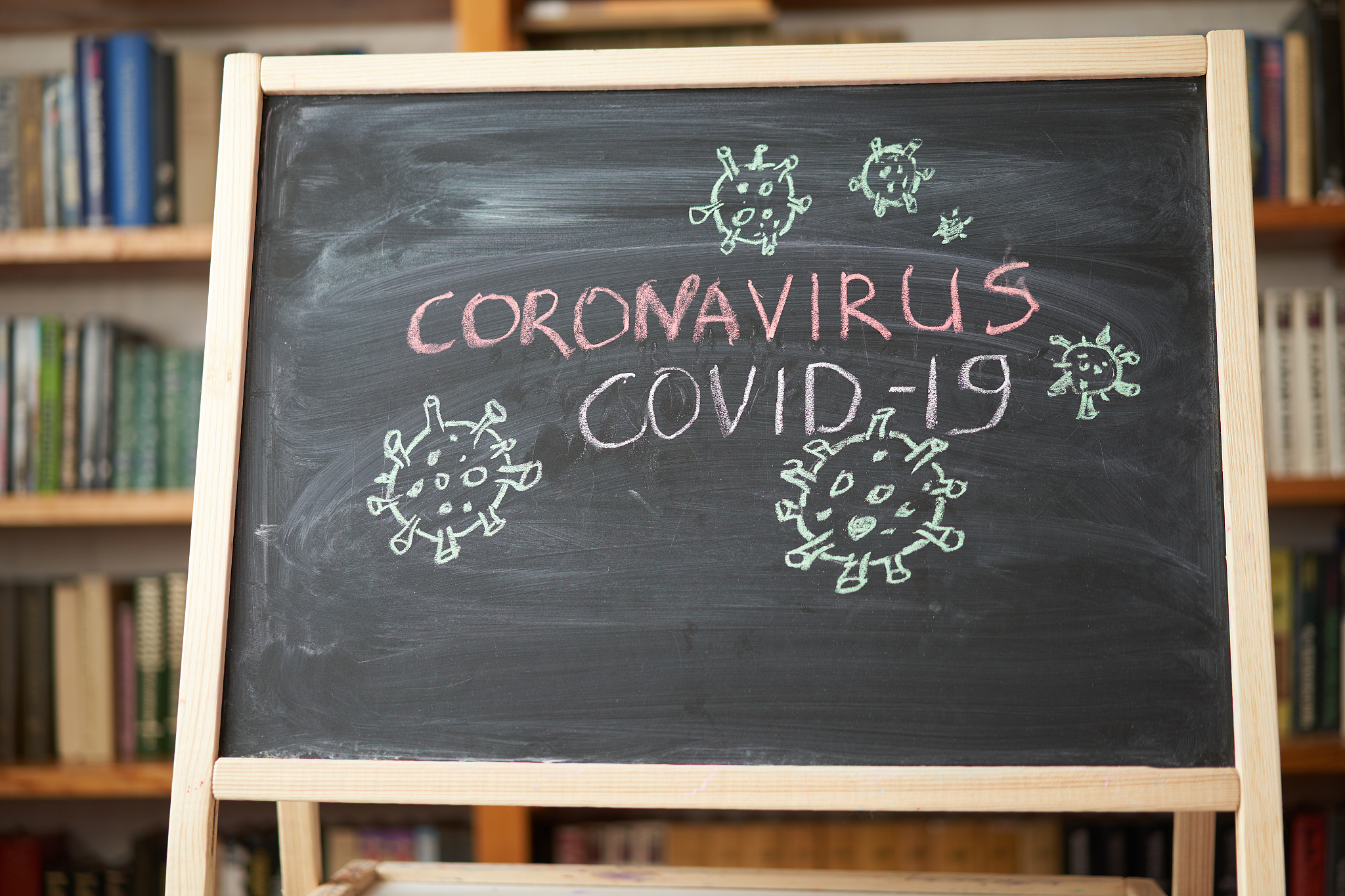 outbreak warning. written white chalk on blackboard in connectio