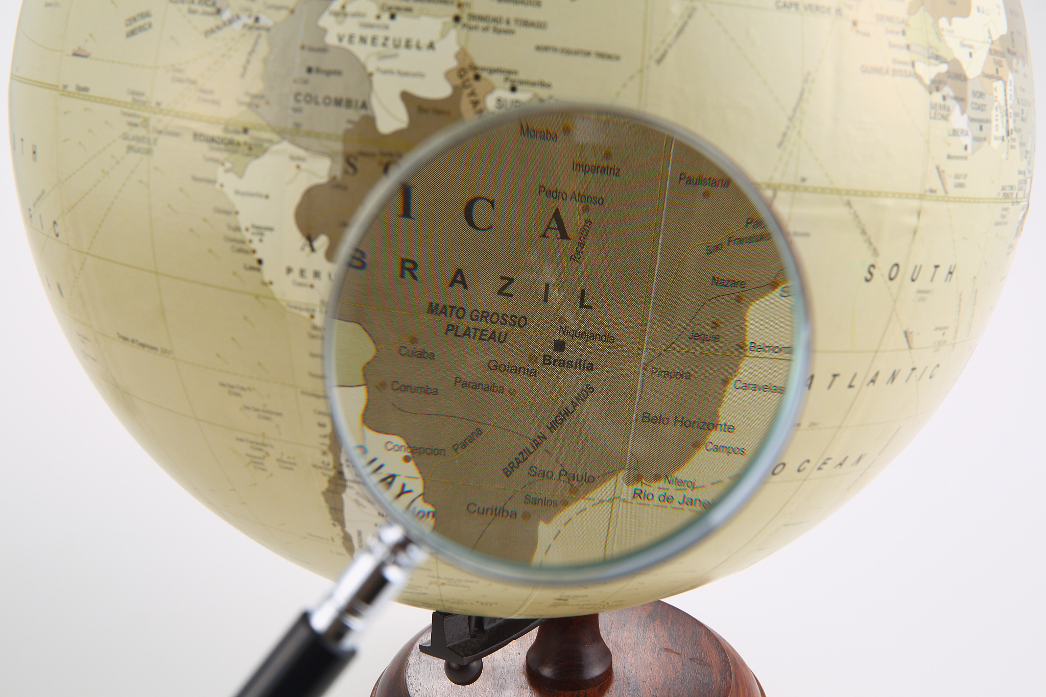 world globe and magnifying glass