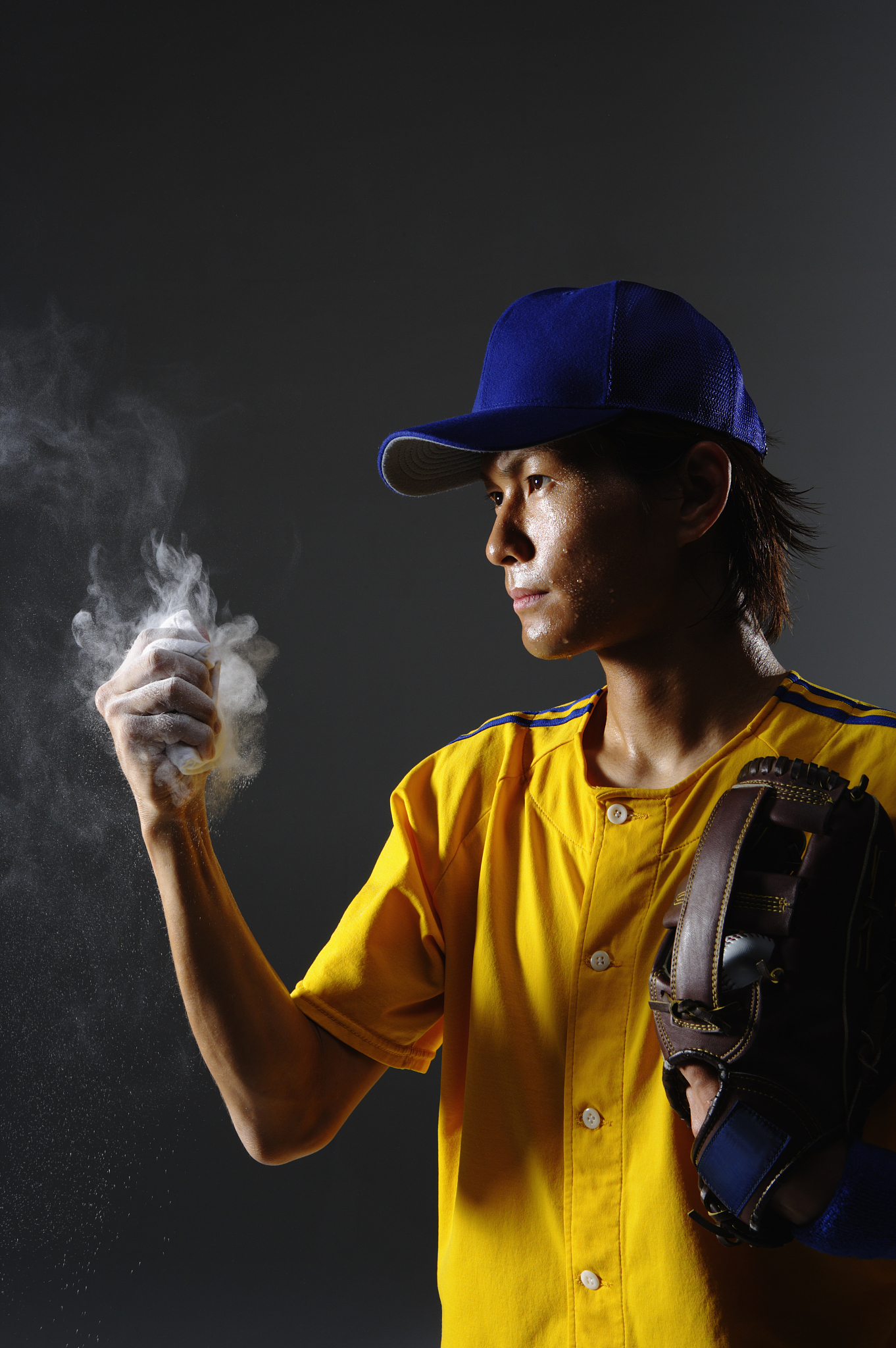 pitcher holding rosin bag, studio shot