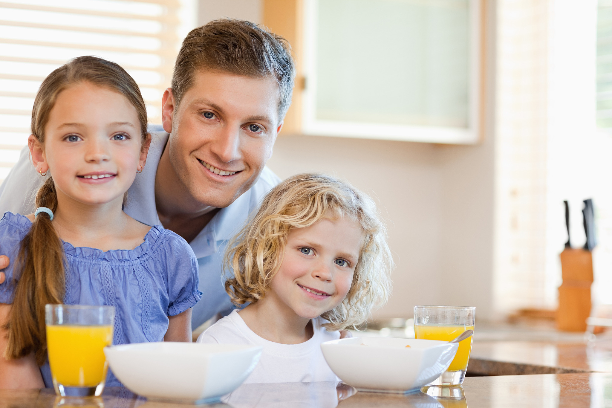 father together with his children in the kitchen