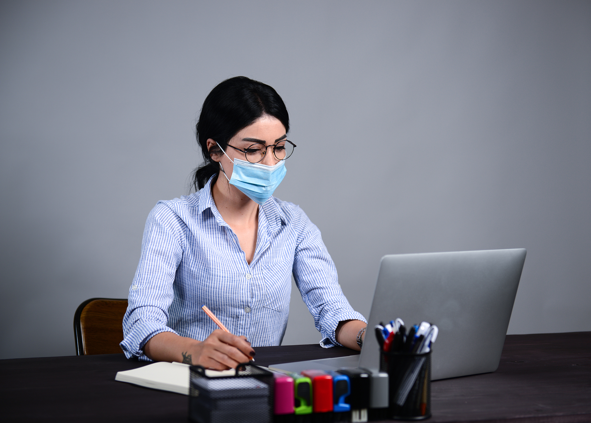 a sick businesswoman wearing a mask