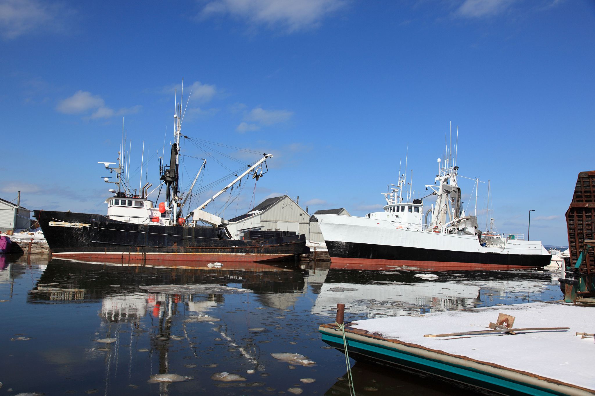 boats at a repair facility located at a wharf in meteghan river,