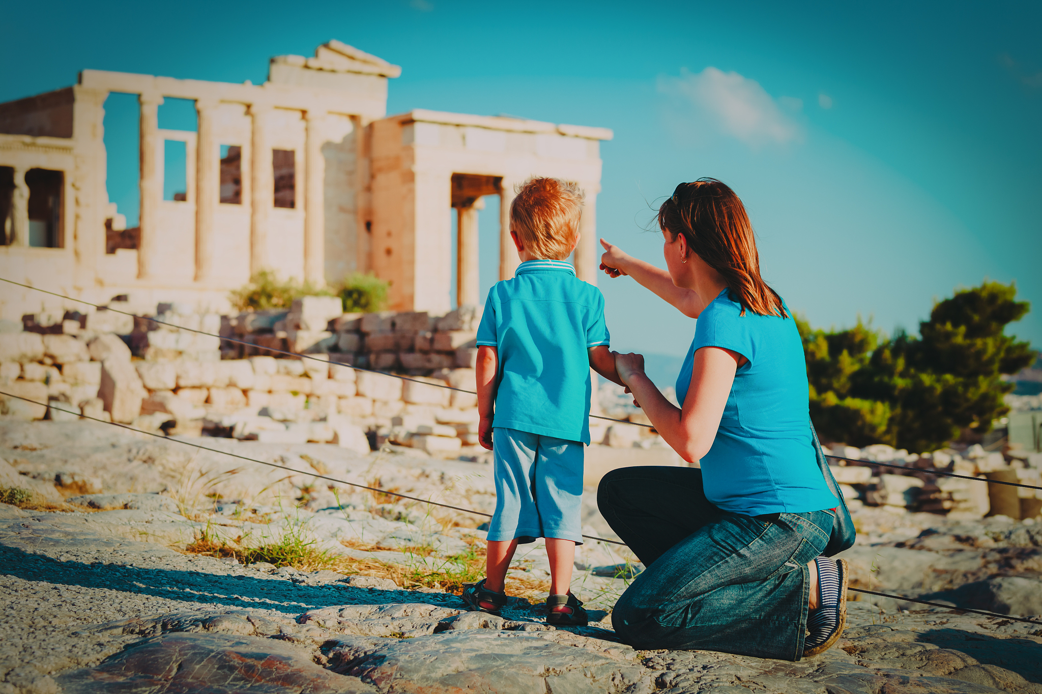mother and son travel in greece, looking at ancient buildings