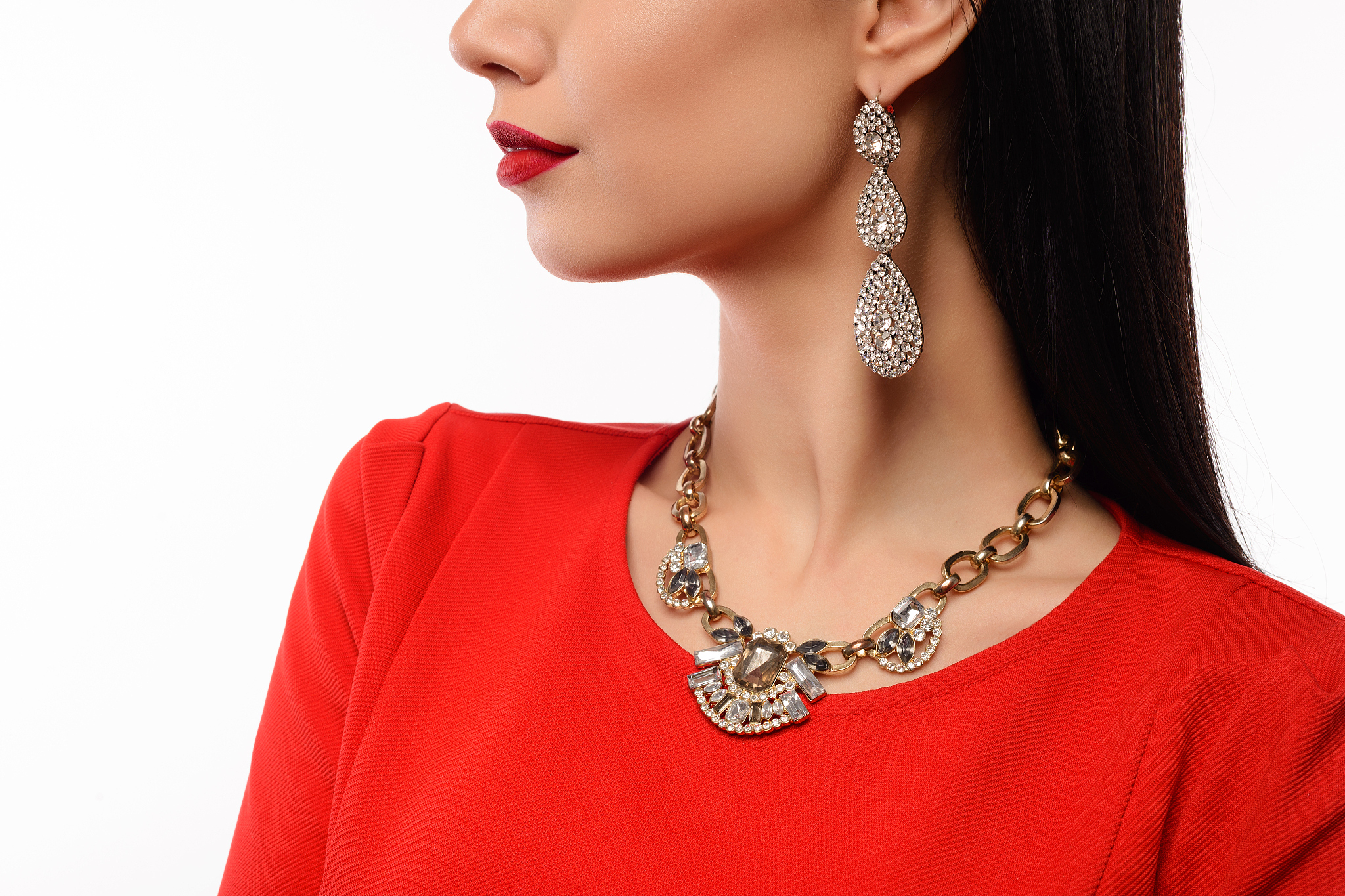 profile of a beautiful woman in red evening dress with necklace 