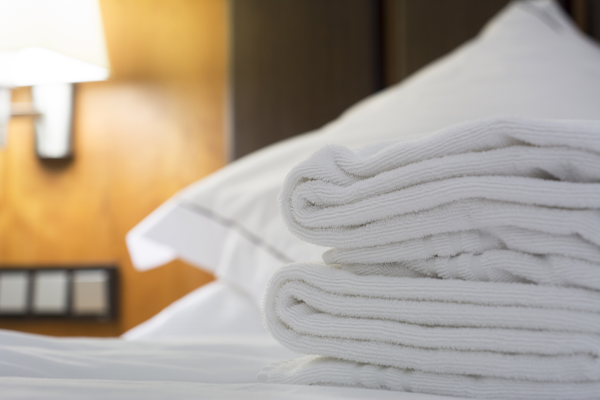hotel bed pillow and white sheets