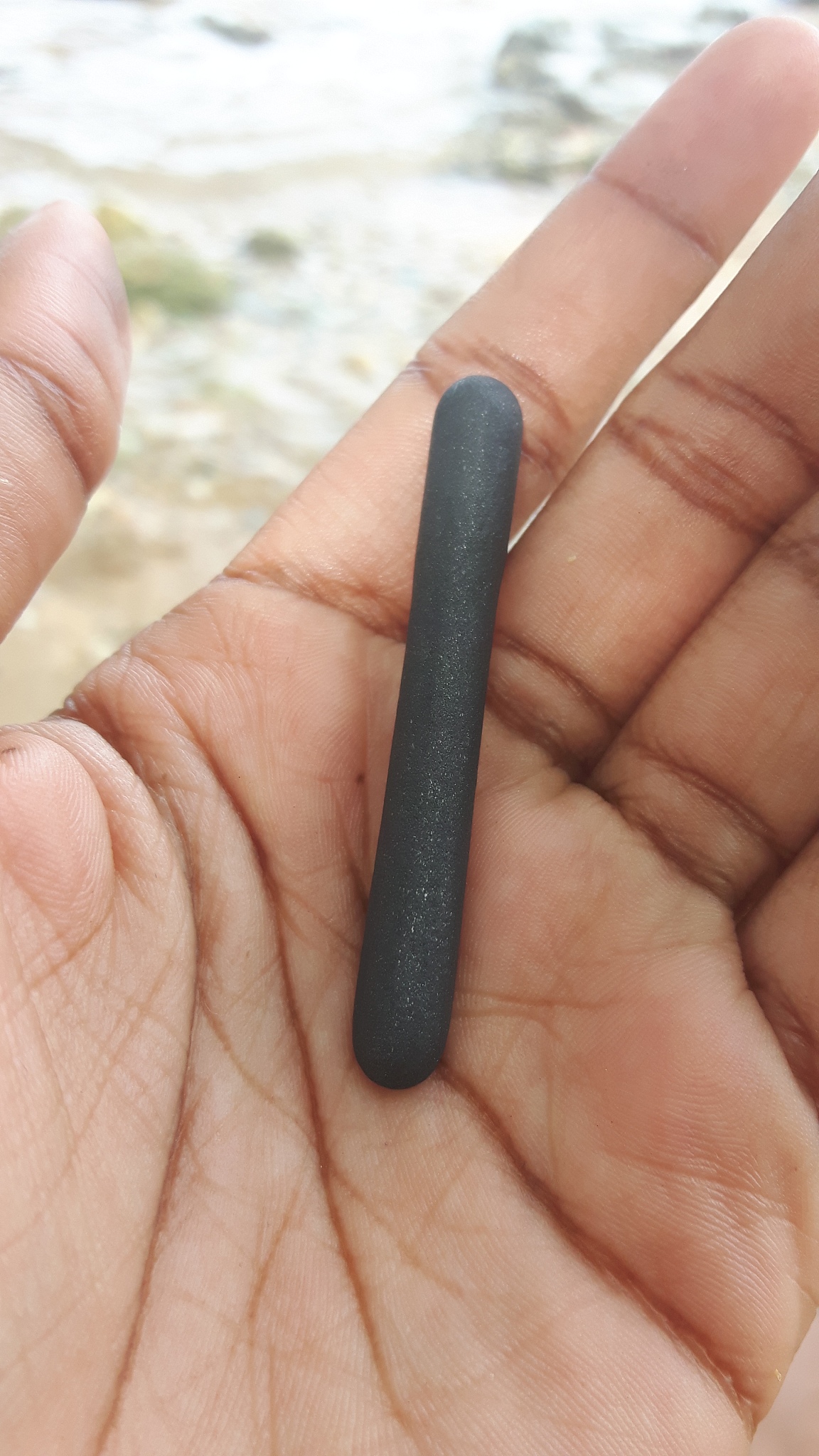 cropped hand holding rock