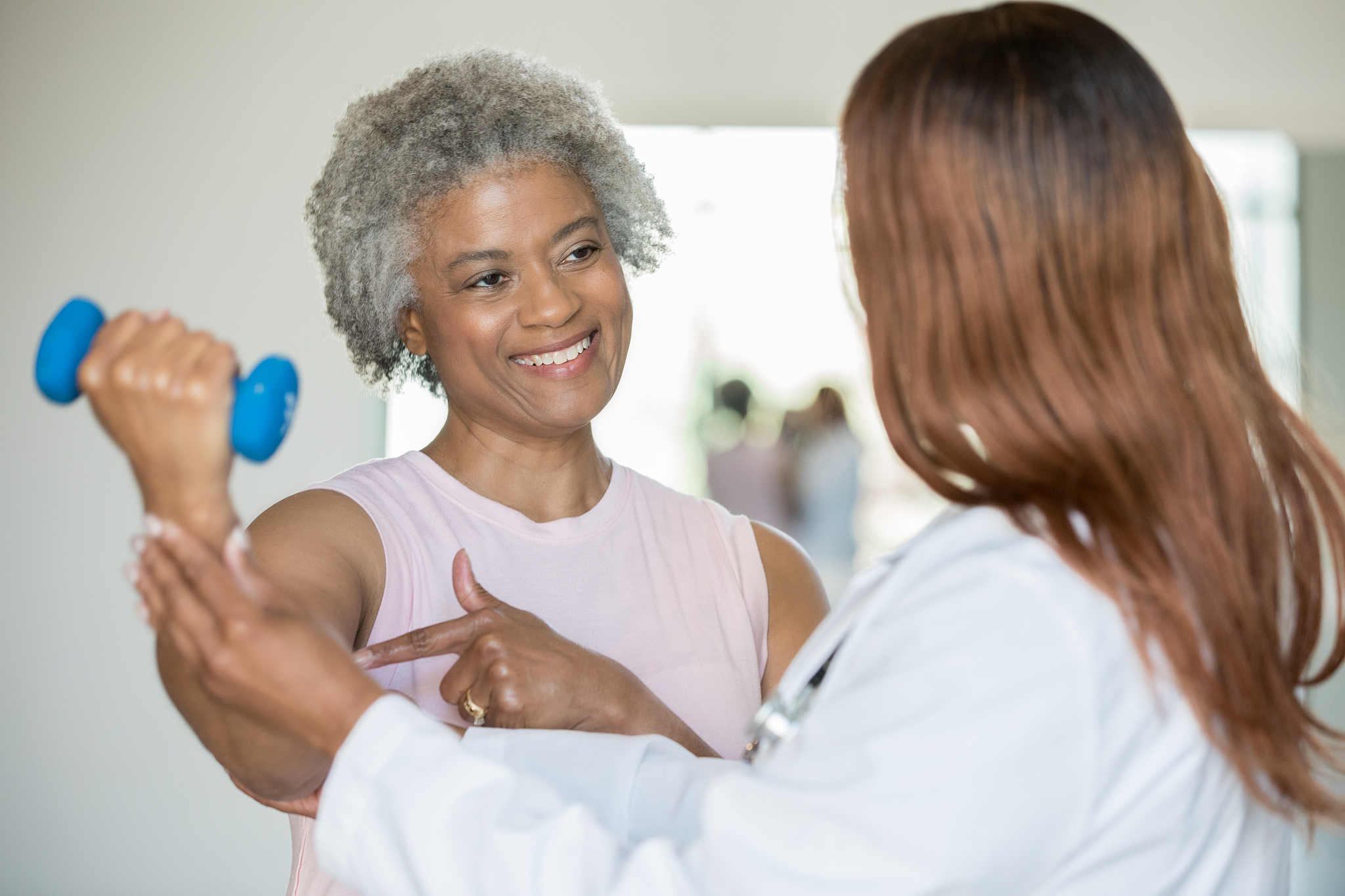 senior lady at physical therapy with therapist